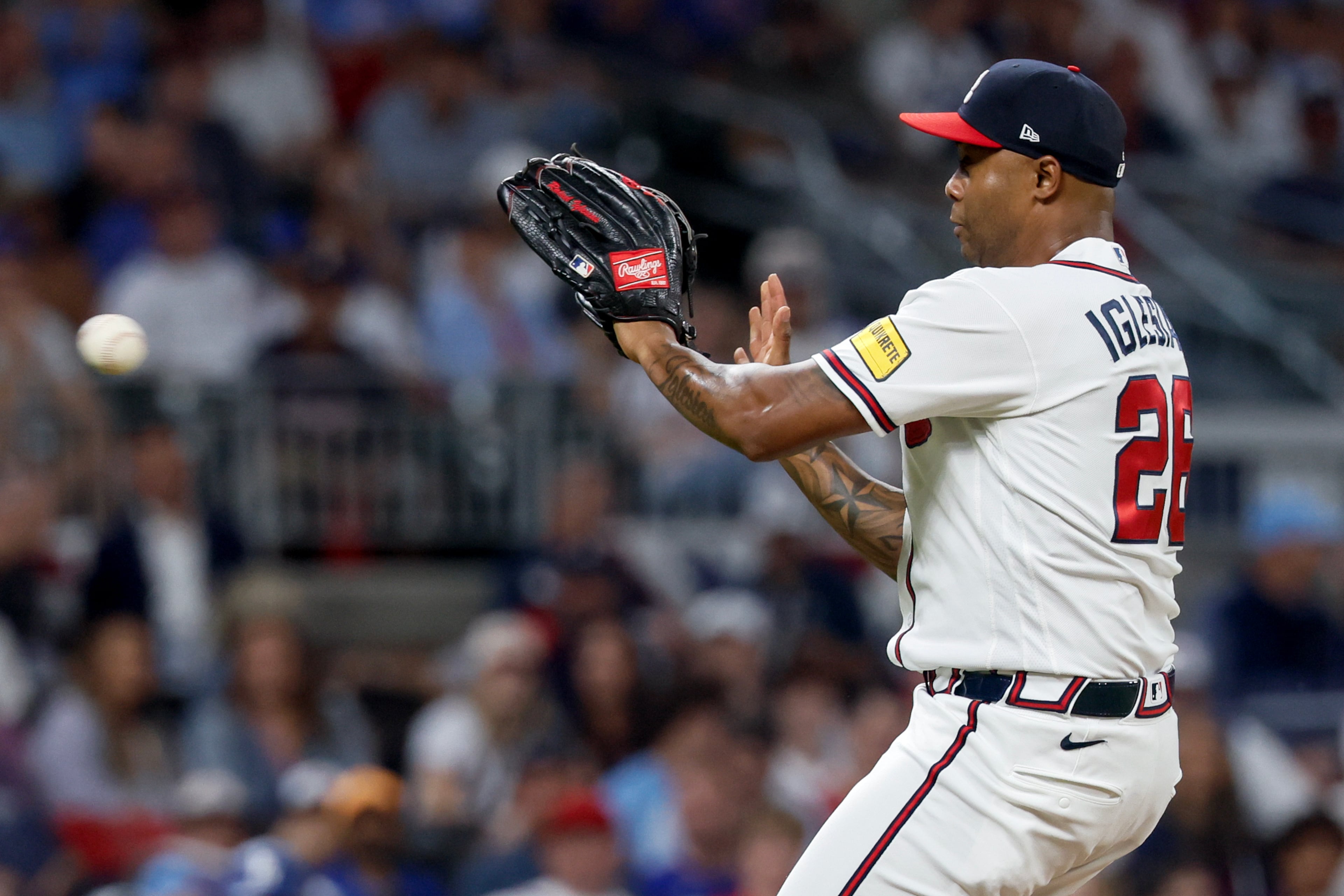 Atlanta Braves pitcher Raisel Iglesias (26) catches a line drive hit by Los Angeles Dodgers' Teoscar Hernandez during the ninth inning of Game 4 of the MLB National League Division Series between the Atlanta Braves and the Los Angeles Dodgers, Wednesday, Oct. 7, 2026, in Atlanta. (Miguel Martinez/AJC)