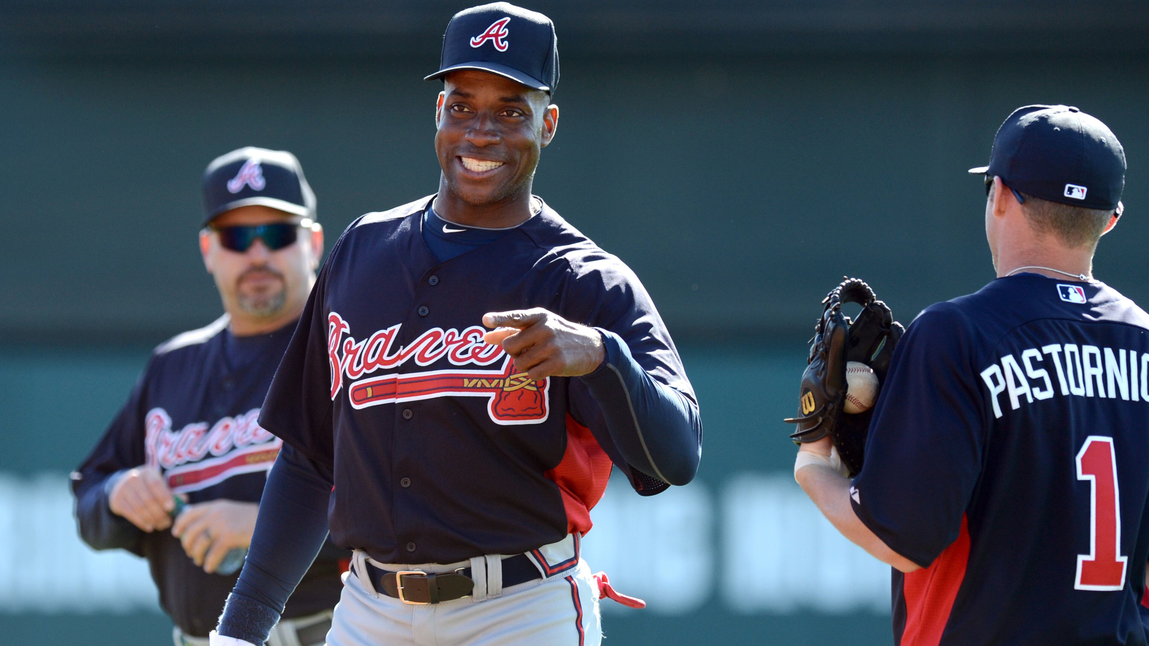 Former Brave Fred McGriff smiles as he talks with infielder Tyler Pastornicky at spring training Feb. 19, 2013 at Champion Stadium in the ESPN Wide World of Sports Complex in Lake Buena Vista, Fla. HYOSUB SHIN / HSHIN@AJC.COM