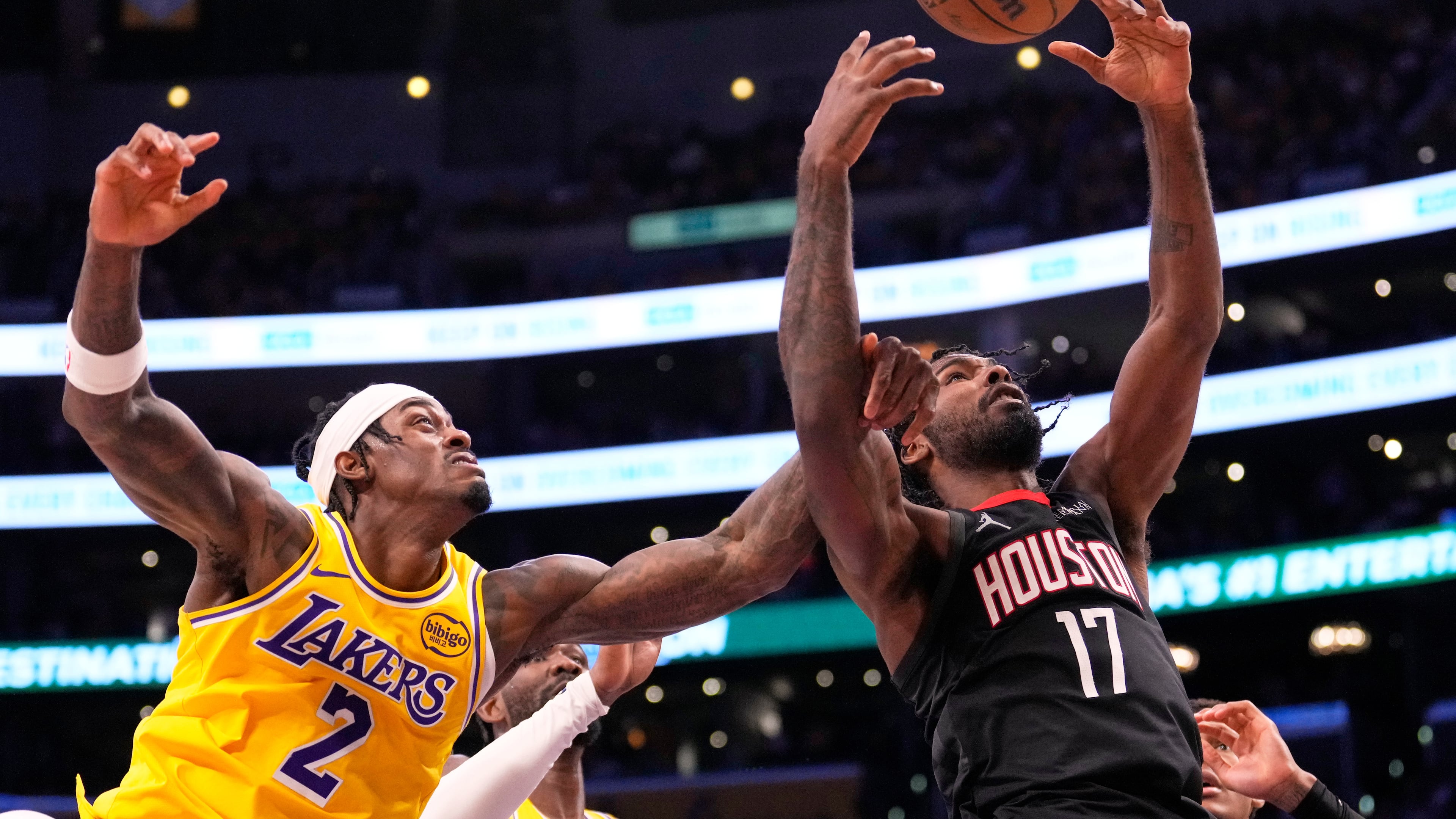 Los Angeles Lakers forward Jarred Vanderbilt, left, and Houston Rockets forward Tari Eason go after a rebound during the second half in Game 1 of a first-round NBA playoffs basketball series Saturday, April 18, 2026, in Los Angeles. (AP Photo/Mark J. Terrill)