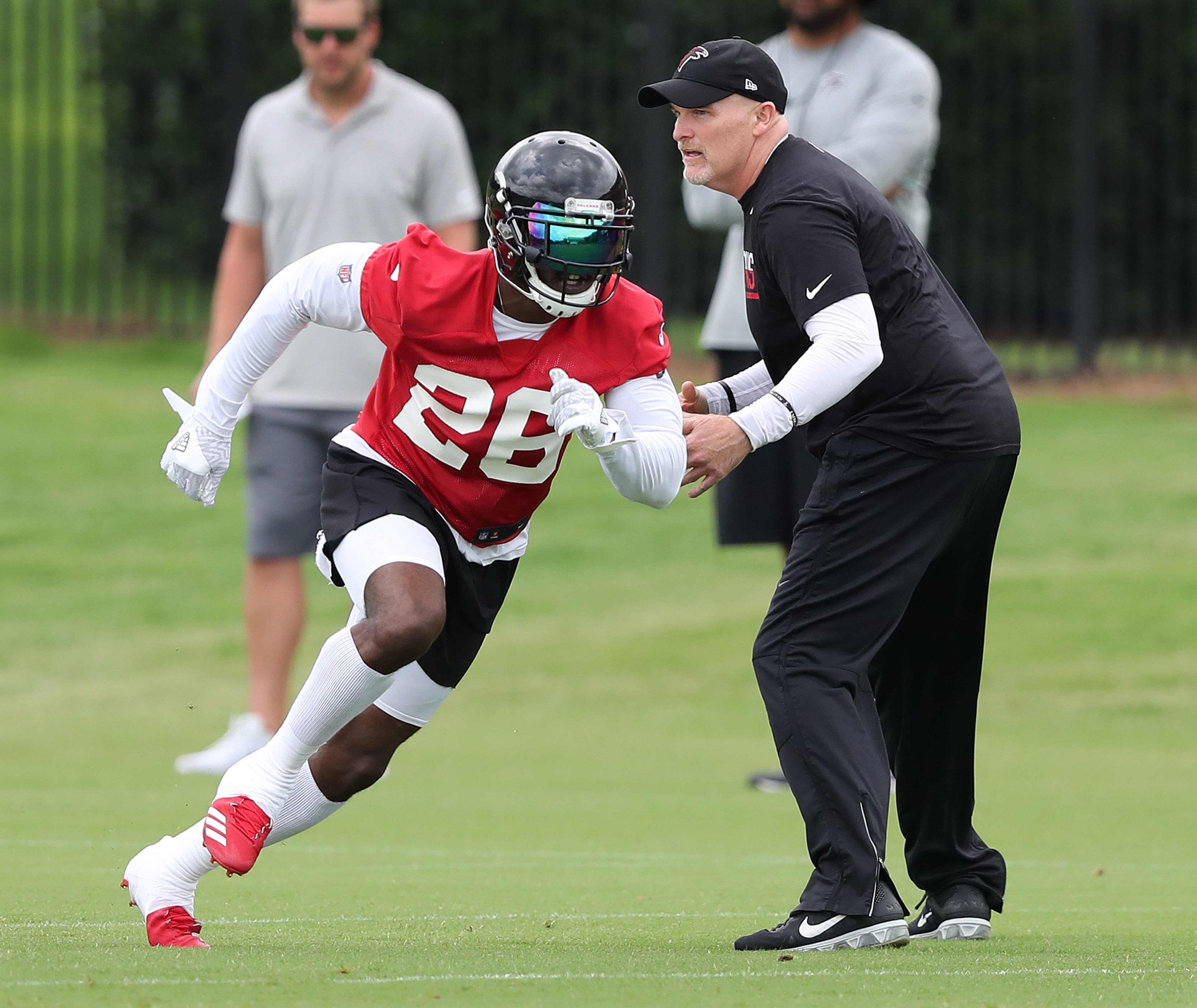 May 30, 2018 Flowery Branch: Atlanta Falcons head coach Dan Quinn works with running back Tevin Coleman during organized team activity on Wednesday, May 30, 2018, in Flowery Branch. Curtis Compton/ccompton@ajc.com