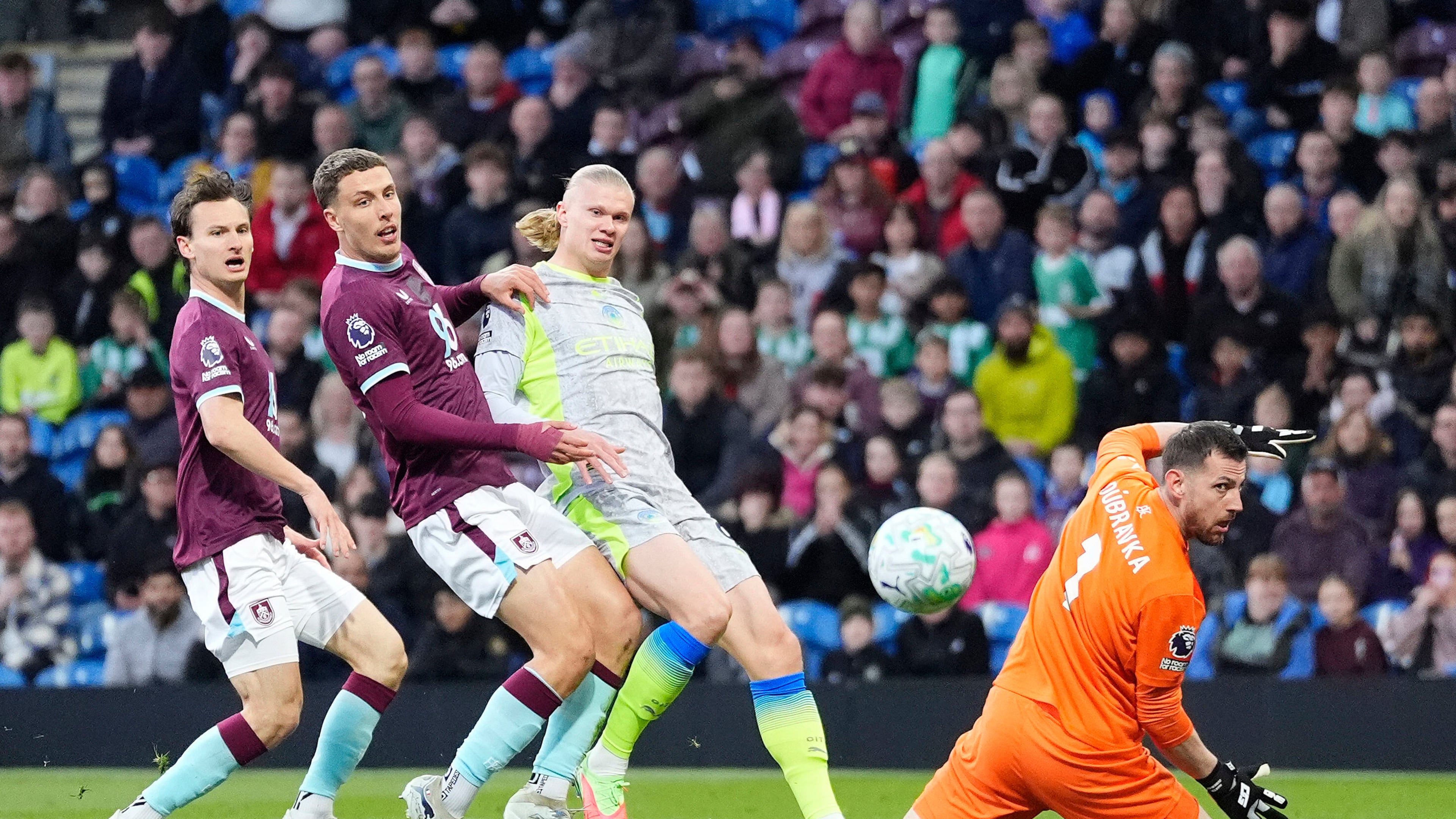Manchester City's Erling Haaland, second right, scores his side's opening goal during the Premier League soccer match between Burnley and Manchester City in Burnley, England, Wednesday, April 22, 2026. (Nick Potts/PA via AP)