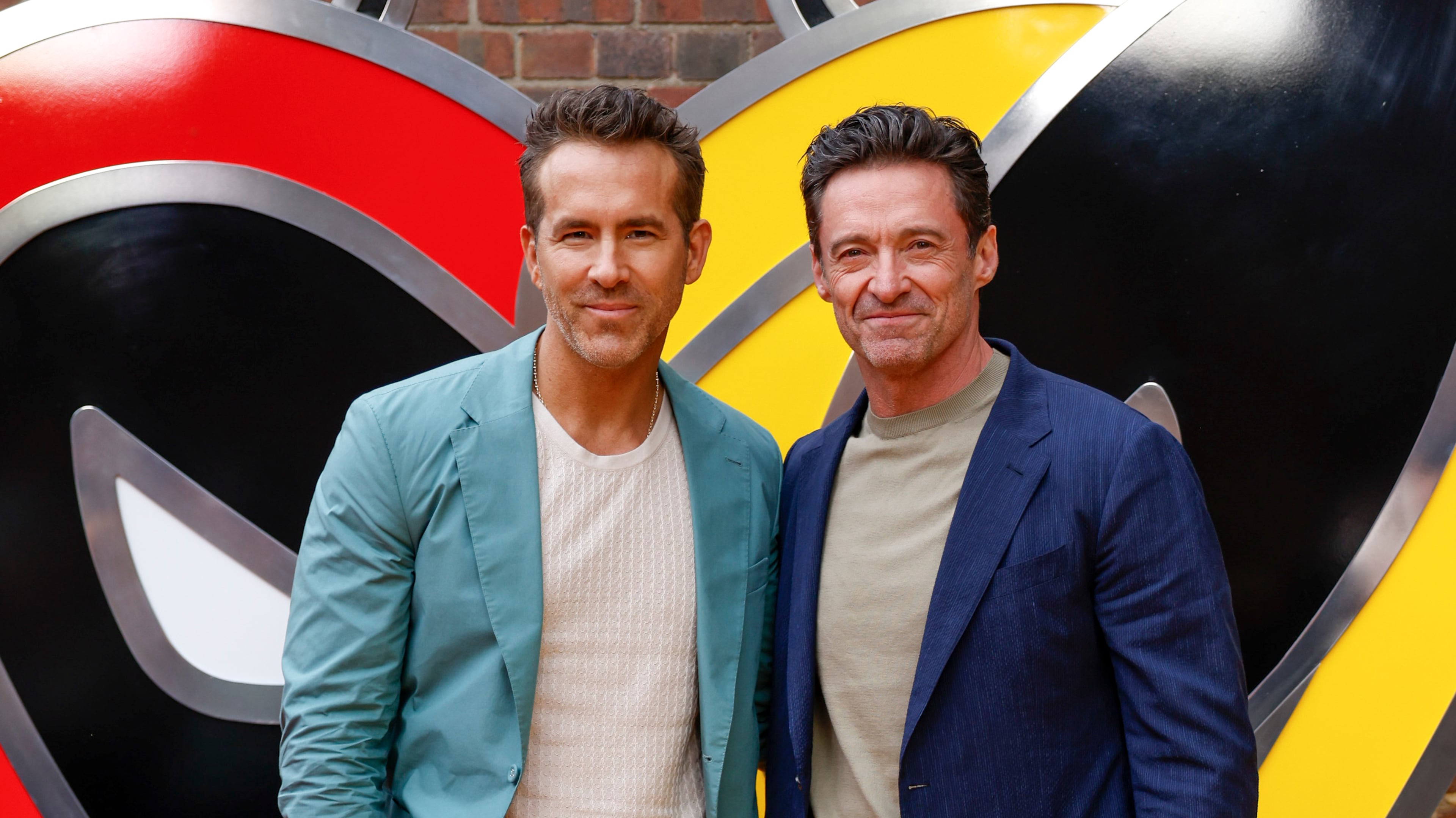 FILE - Ryan Reynolds, left, and Hugh Jackman pose for photographers upon arrival at the screening of the film "Deadpool & Wolverine" on July 11, 2024 in London. (Photo by Millie Turner/Invision/AP, File)