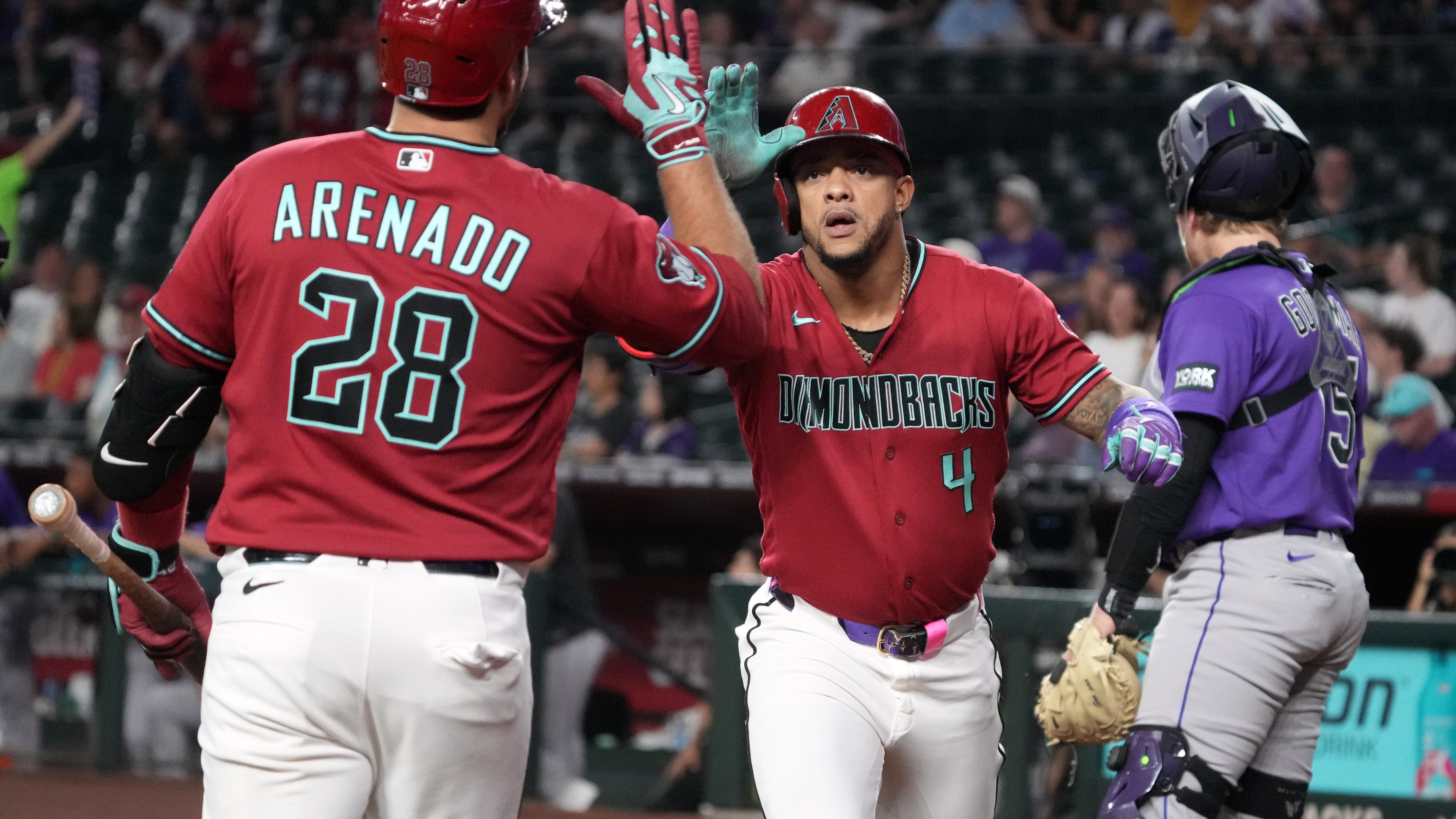 Arizona Diamondbacks' Ketel Marte celebrates with Nolan Arenado (28) after hitting a solo home run against the Colorado Rockies in the first inning of a baseball game, Tuesday, Aug. 11, 2026, in Phoenix. (AP Photo/Rick Scuteri)