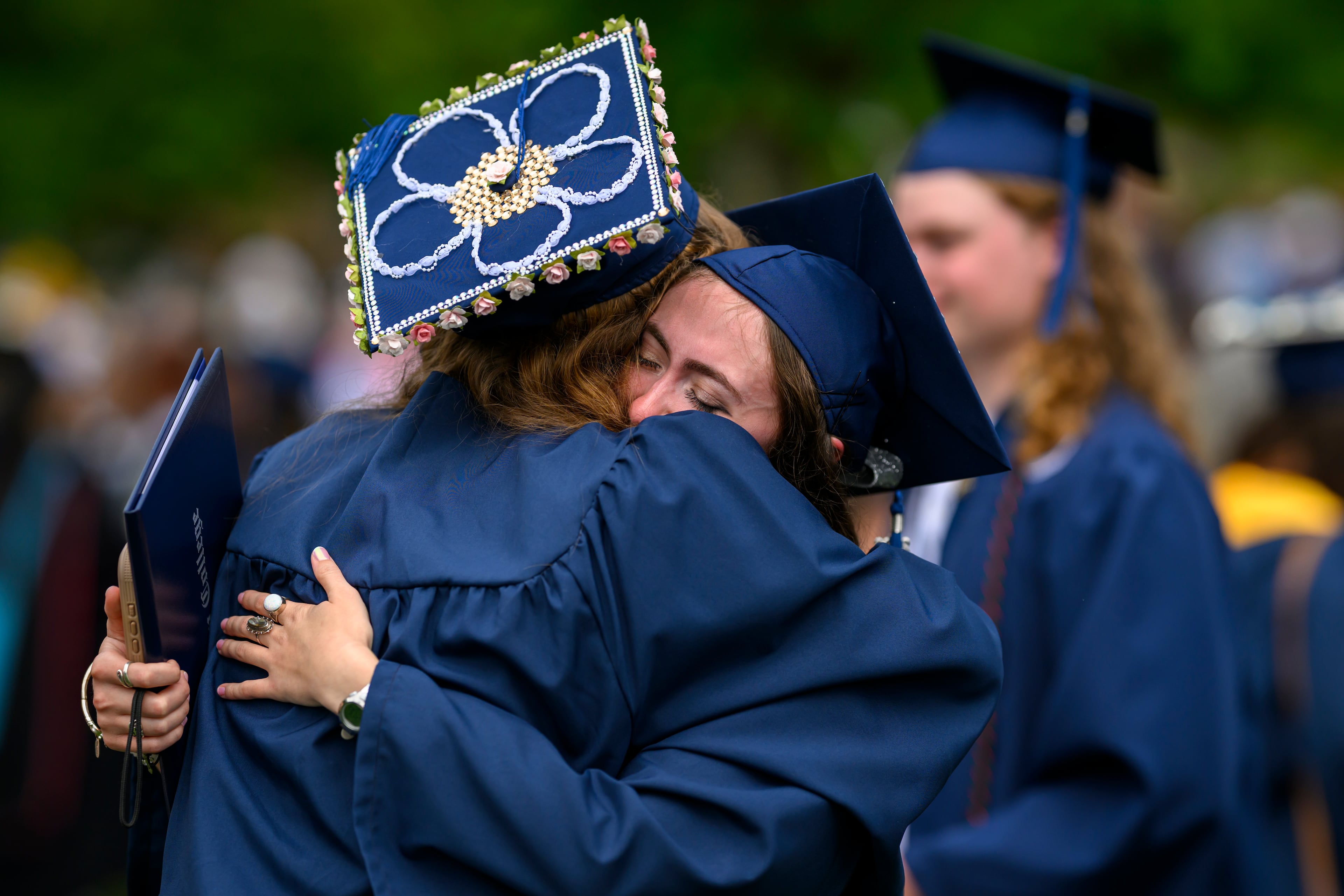 Berry College graduates Amelia Ousley (left) and Lauren Beatty hug following the commencement ceremony on Saturday, May 9, 2026. (Brant Sanderlin/Berry College)