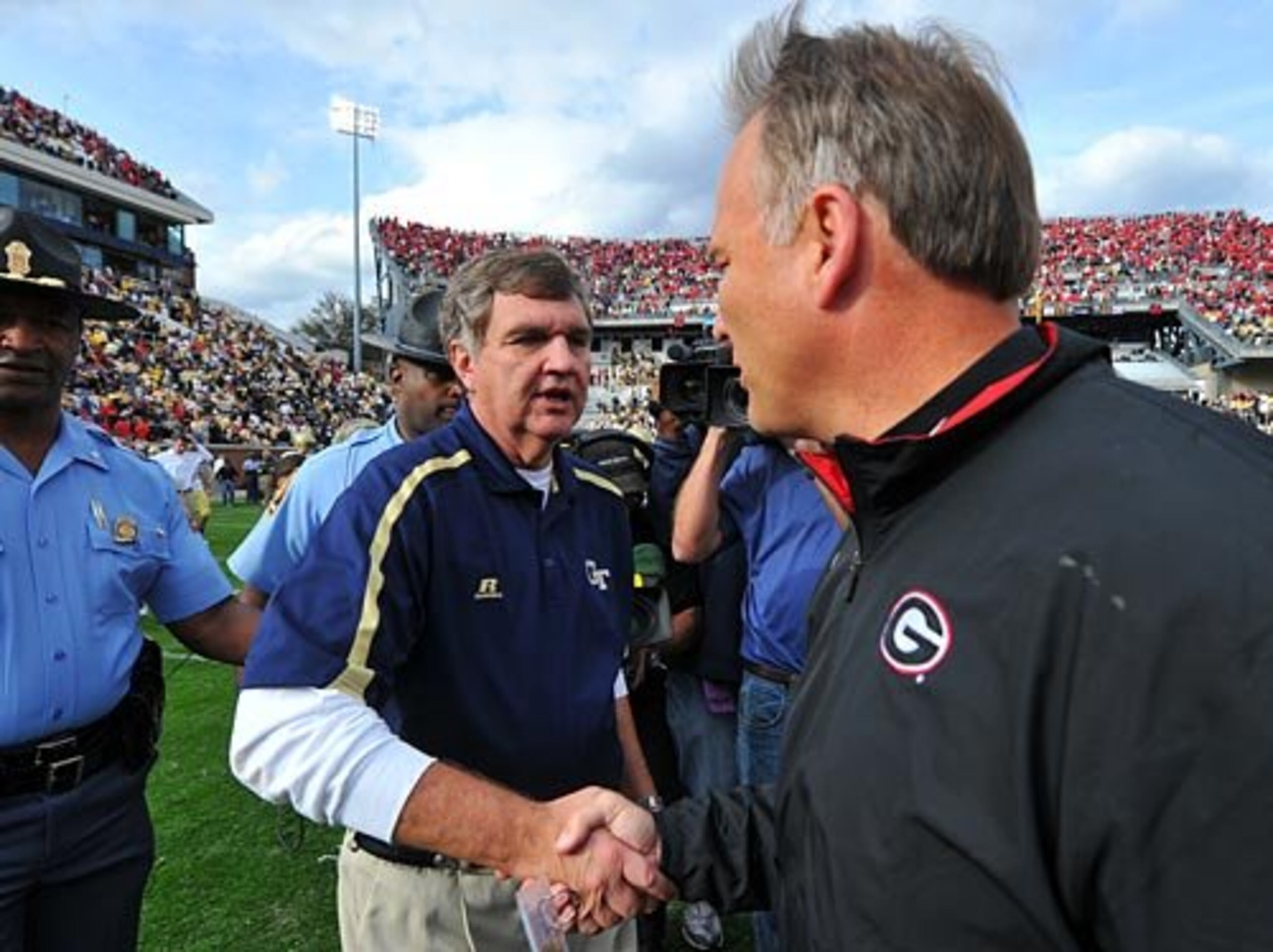 Tech head coach Paul Johnson, left, congratulates Georgia head coach Mark Richt following the Bulldogs' victory over the Yellow Jackets.