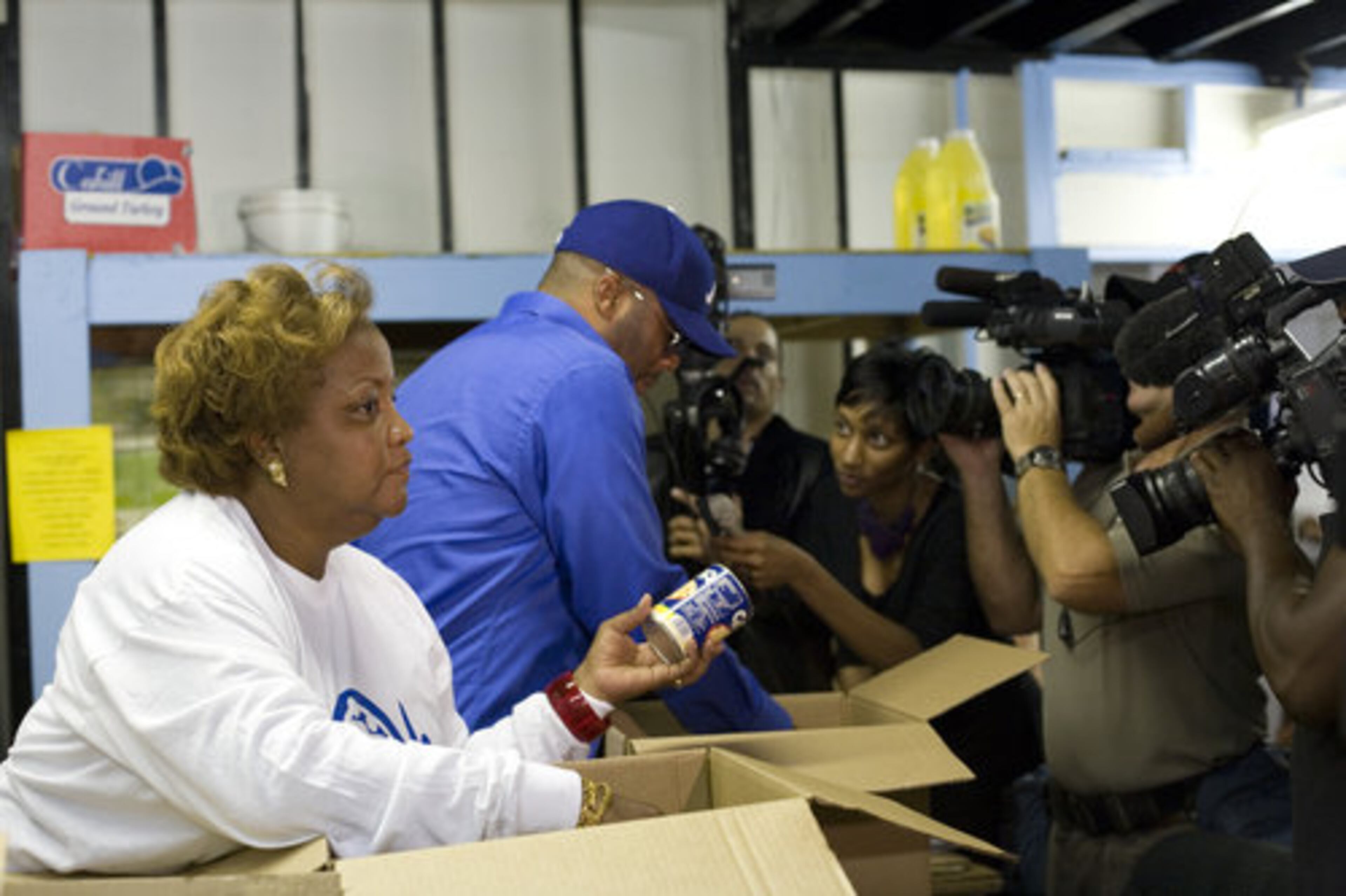 Omilami and Perry packed boxes with some of the donated food. Food pantries across metro Atlanta and the United States have been feeling the fallout of a troubled economy.