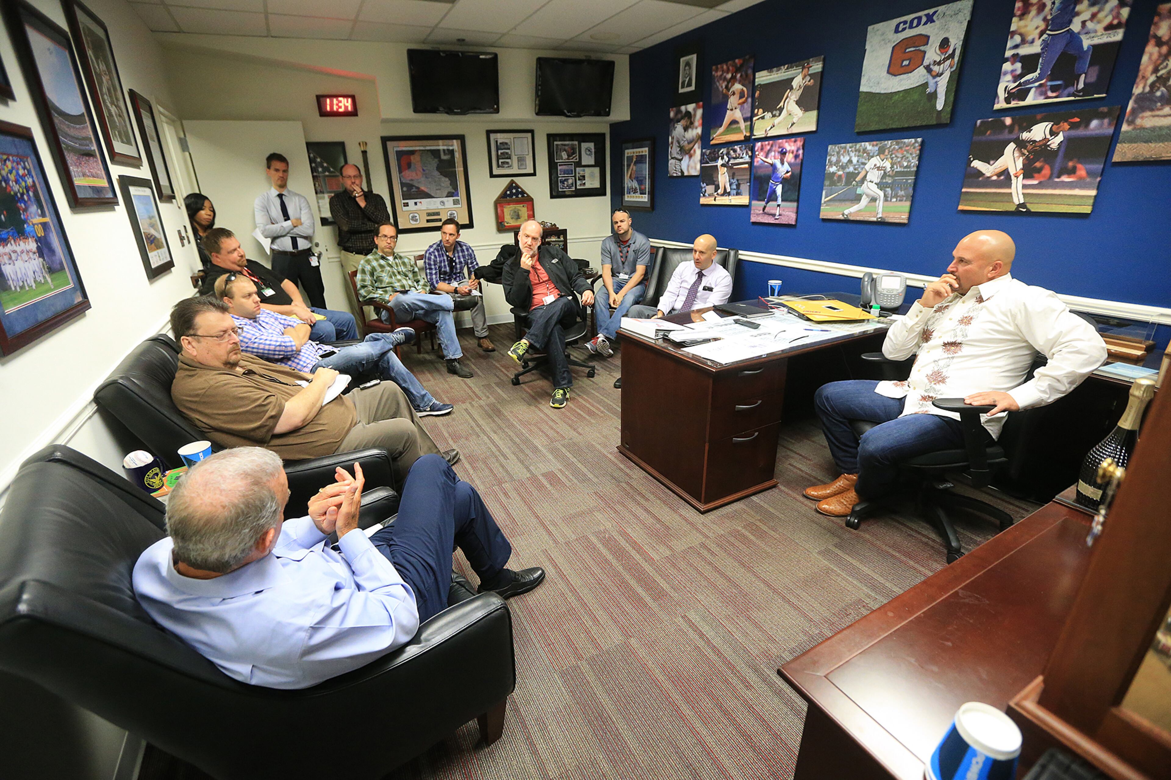Braves manager Fredi Gonzalez (right), general manager John Coppolella (second from right), and president of baseball operations John Hart (far left) hold an end of season interview with the media in the team clubhouse on Monday, Oct. 5, 2015, in Atlanta. Curtis Compton / ccompton@ajc.com