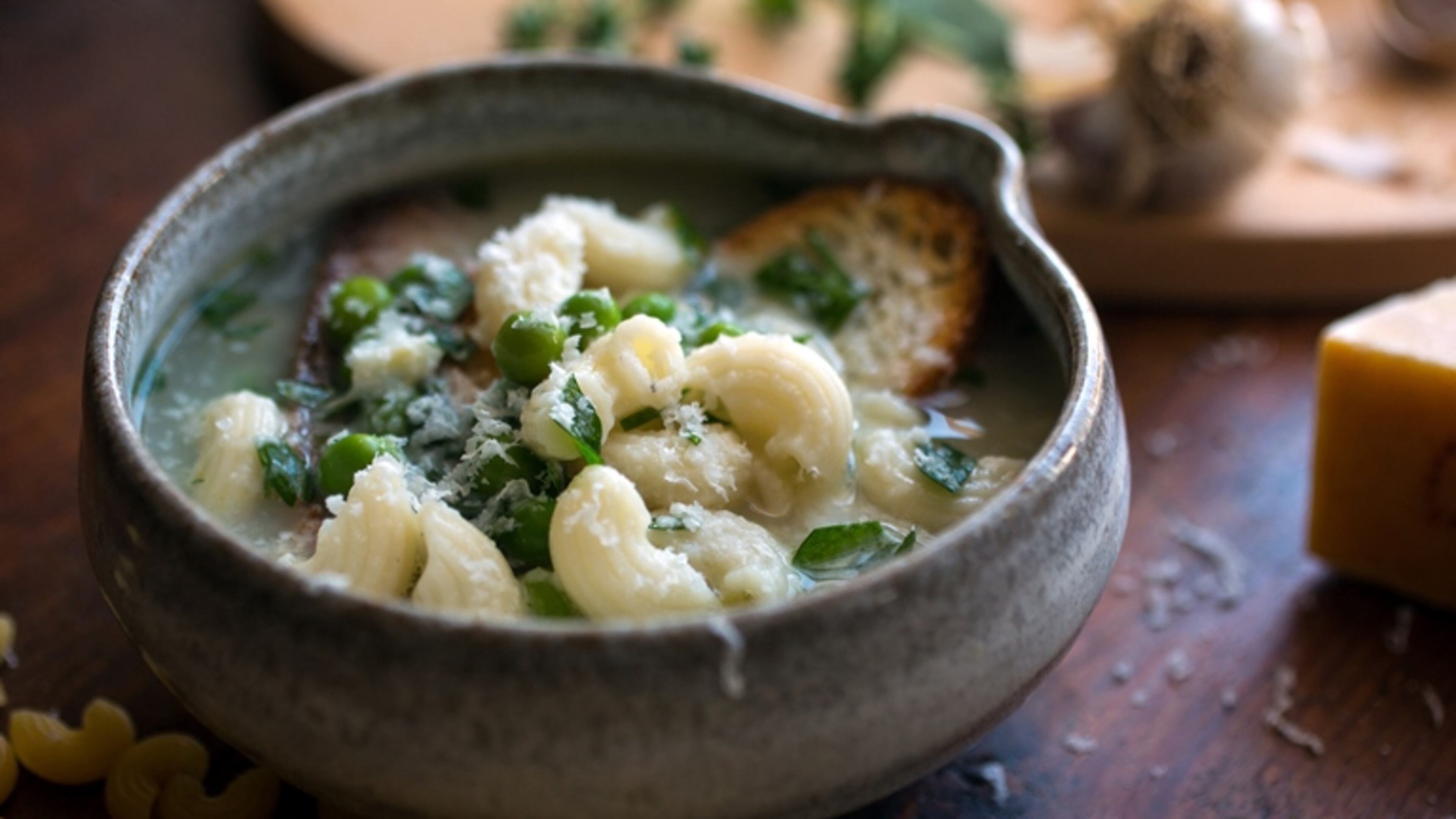 A crock of garlic soup, with macaroni pasta, peas, thyme and grated Parmesan or Gruyere, in New York, Sept. 4, 2015. Based on a Provencal recipe, this soup that can work as an easy dinner requires a minimal number of the staples that are often already on hand.