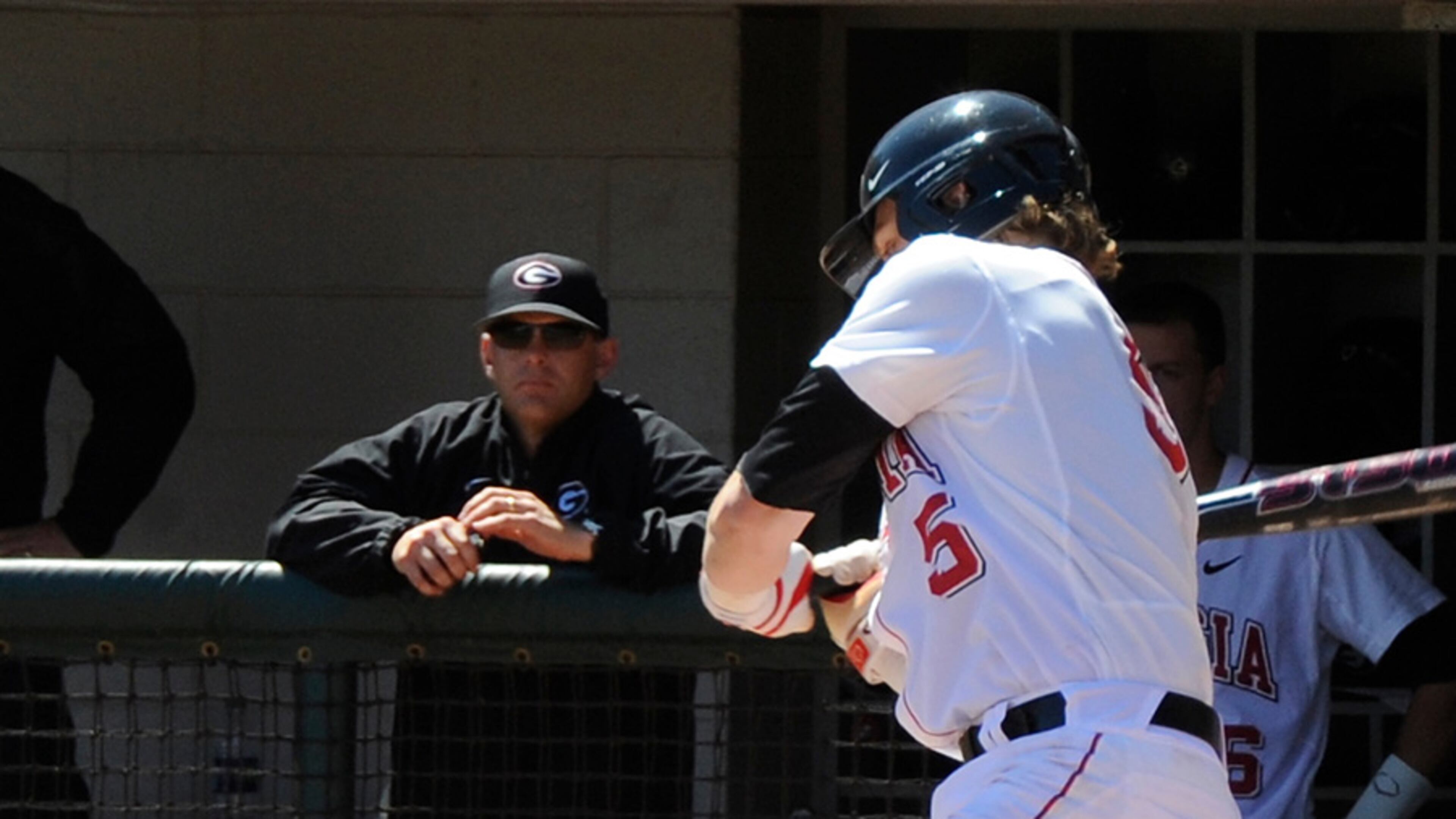 Scott Stricklin (background) in his first year as Georgia's baseball coach.