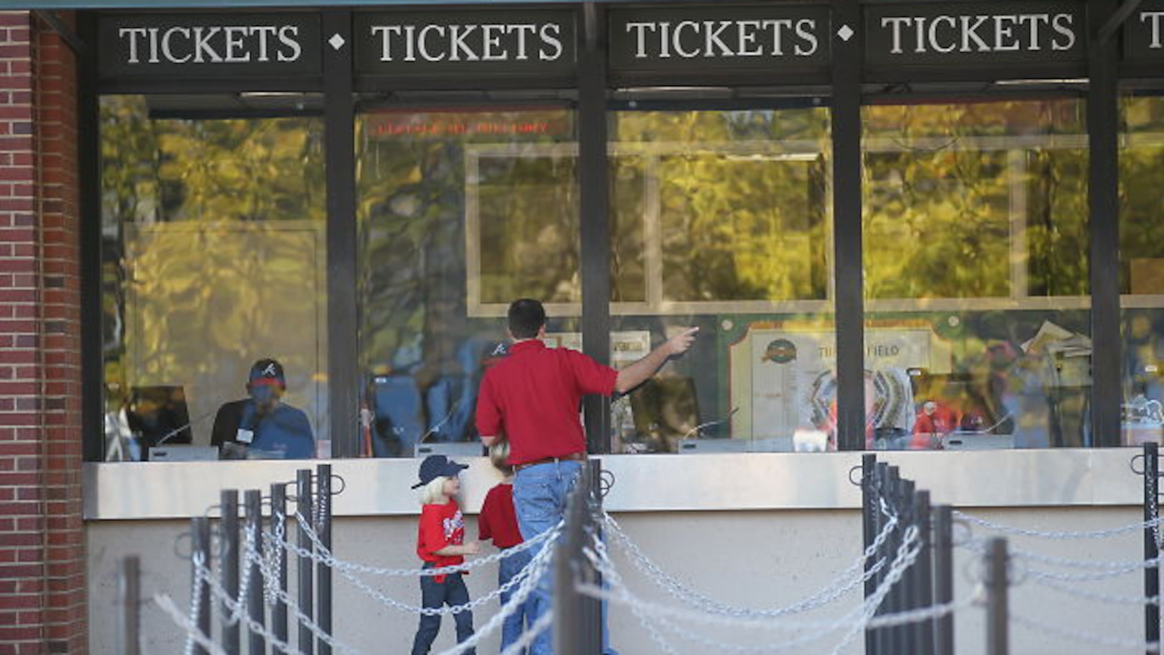 At the ticket booth at Turner Field on Friday morning are Brian Henderson of Marietta with children Macey, 3, (in hat) and Parker, 5.