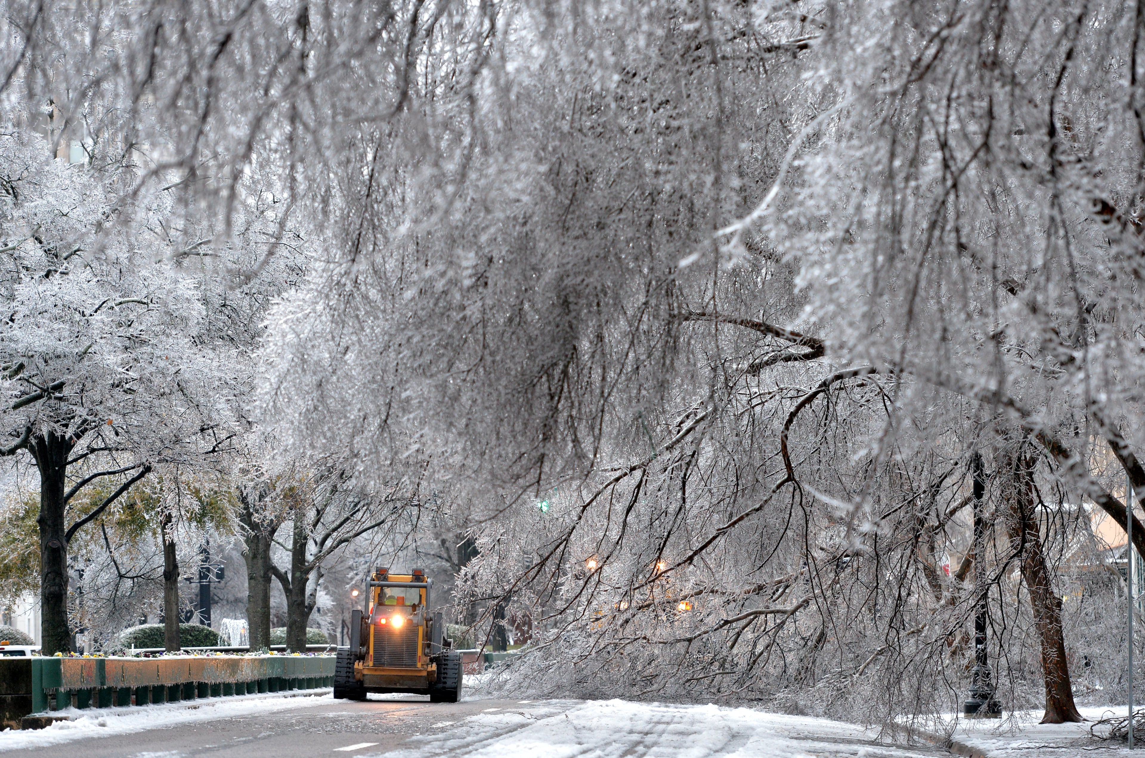 Augusta city crew cleans up fallen trees off Broad Street in downtown Augusta on Thursday, February 13, 2014. HYOSUB SHIN / HSHIN@AJC.COM