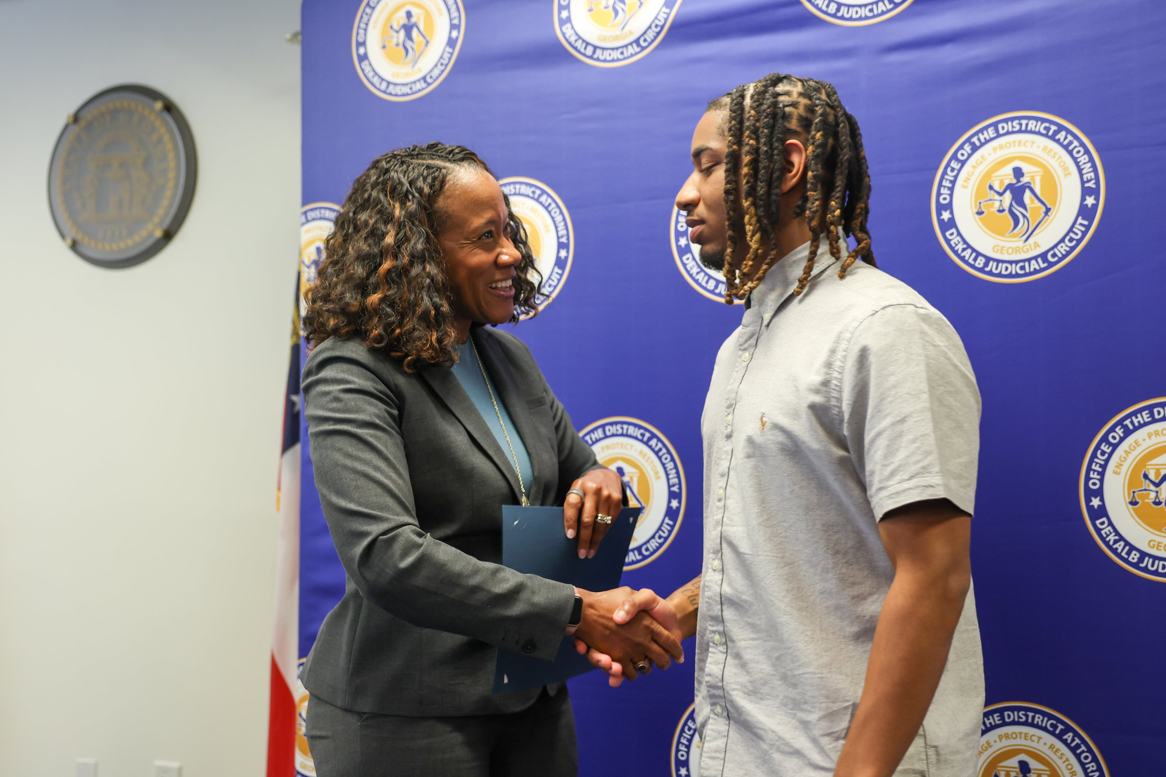 DeKalb County District Attorney Sherry Boston (left) presents a certificate to Amir Gilbert during the STRIDE graduation ceremony on Monday, Sept. 28, 2026, in Decatur. (Arvin Temkar/AJC)