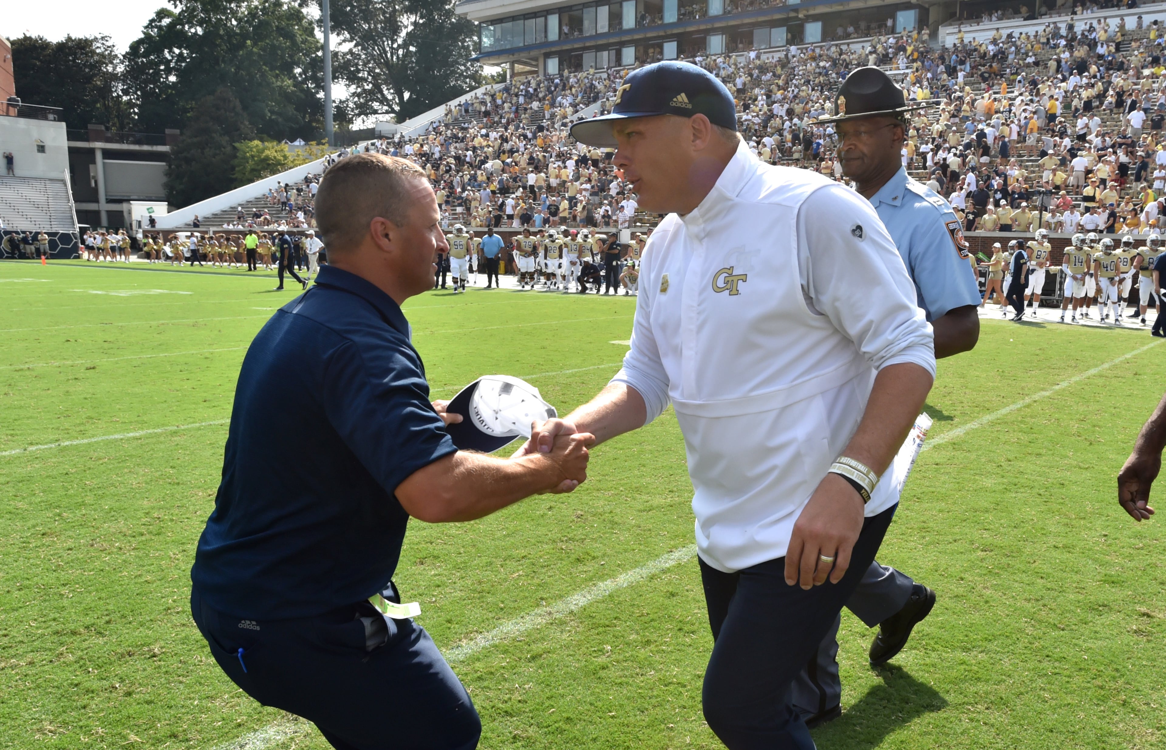 Citadel head coach Brent Thompson and Georgia Tech head coach Geoff Collins shake hands after Citadel won 27-24. (Hyosub Shin / Hyosub.Shin@ajc.com)