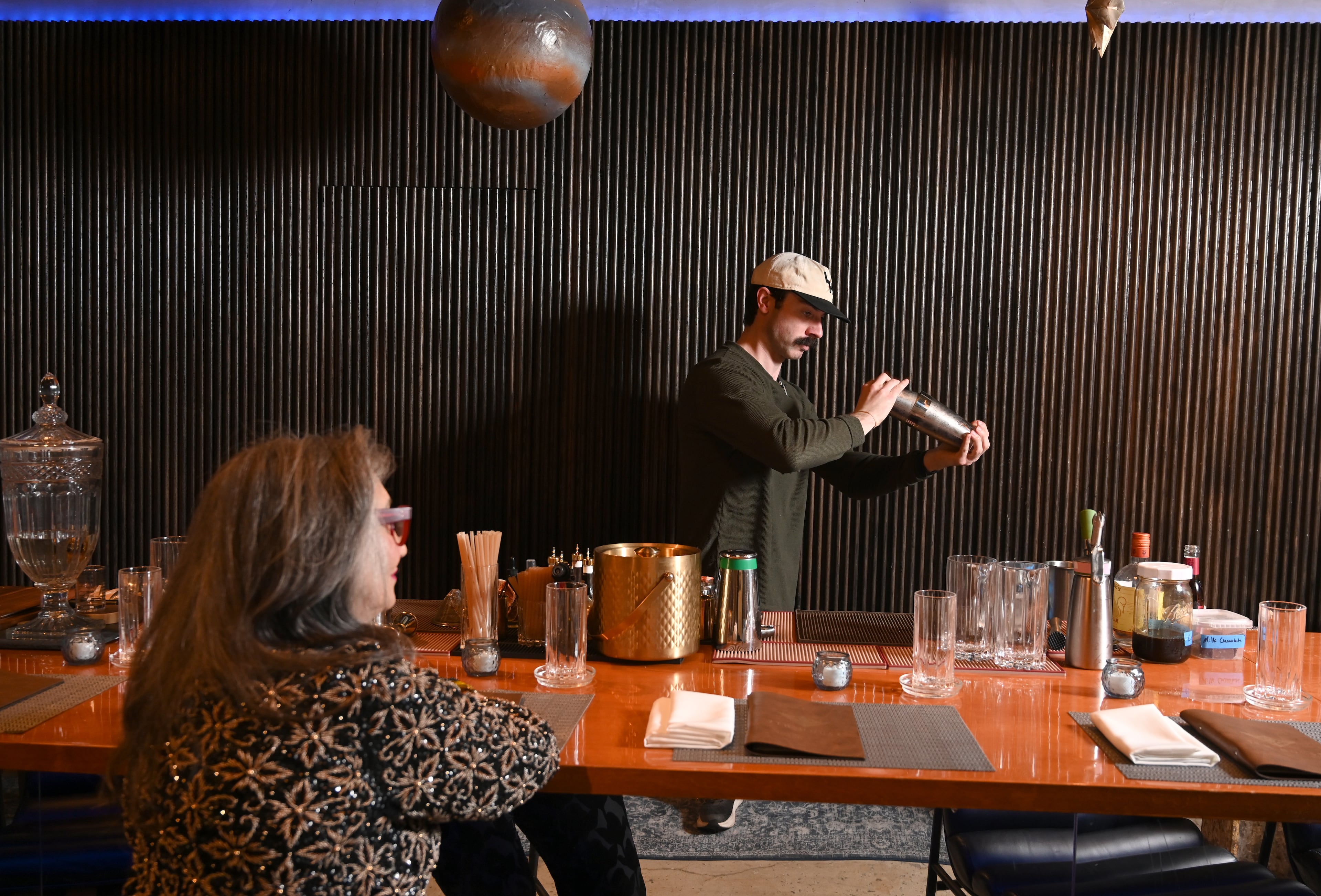 Trenton Austin, general manager at 7th House, makes Rolene Jaffe her favorite nonalcoholic drink. Each drink at the Atlanta restaurant is aligned to a zodiac sign, its ingredients chosen to reflect the personality of that sign. (Hyosub Shin/AJC)