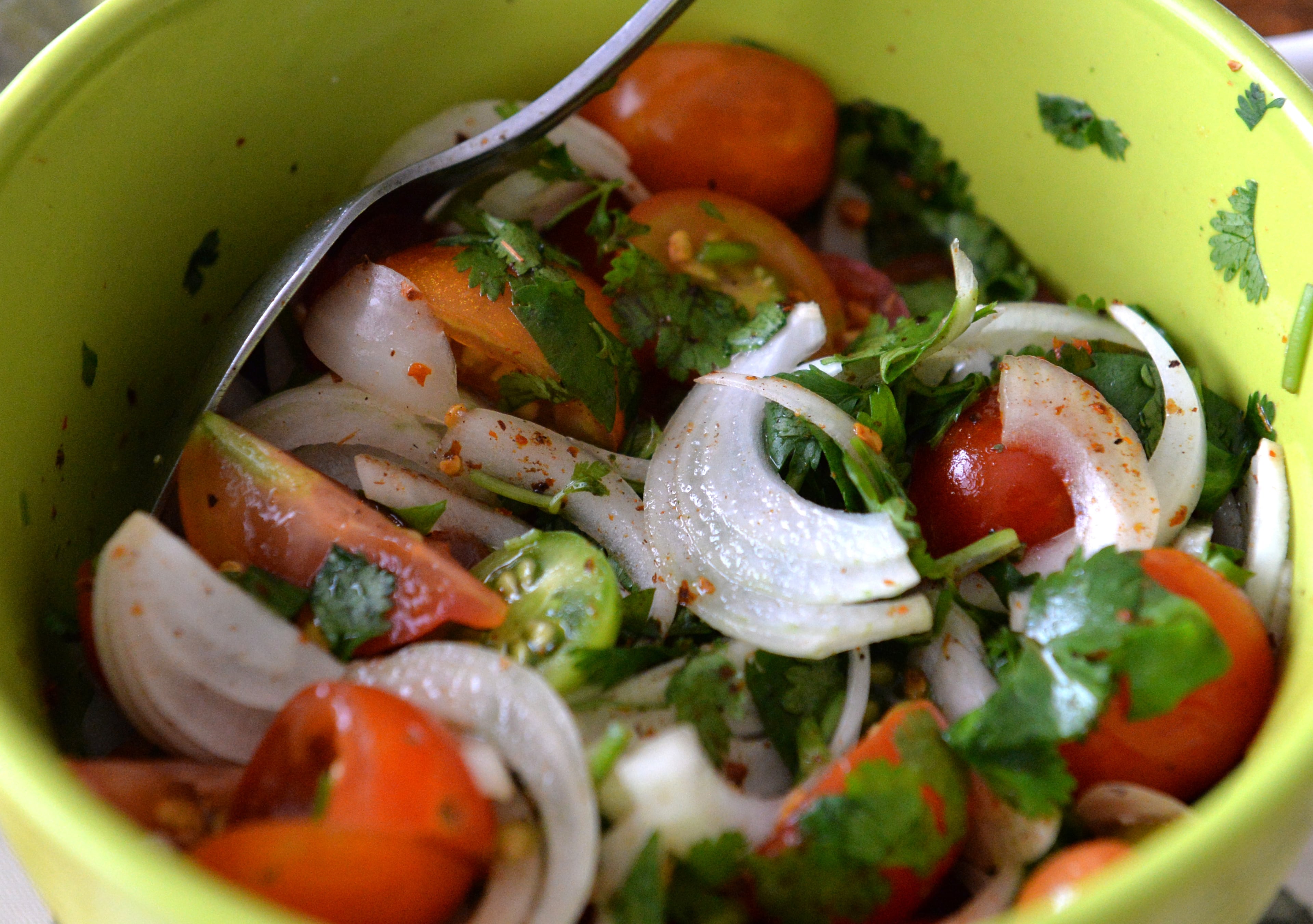 A dinner prepared by Noela Men, who is originally from Burma, mostly with vegetables she harvested from their farm, at her home in Suwanee on Saturday, June 21, 2014. HYOSUB SHIN / HSHIN@AJC.COM