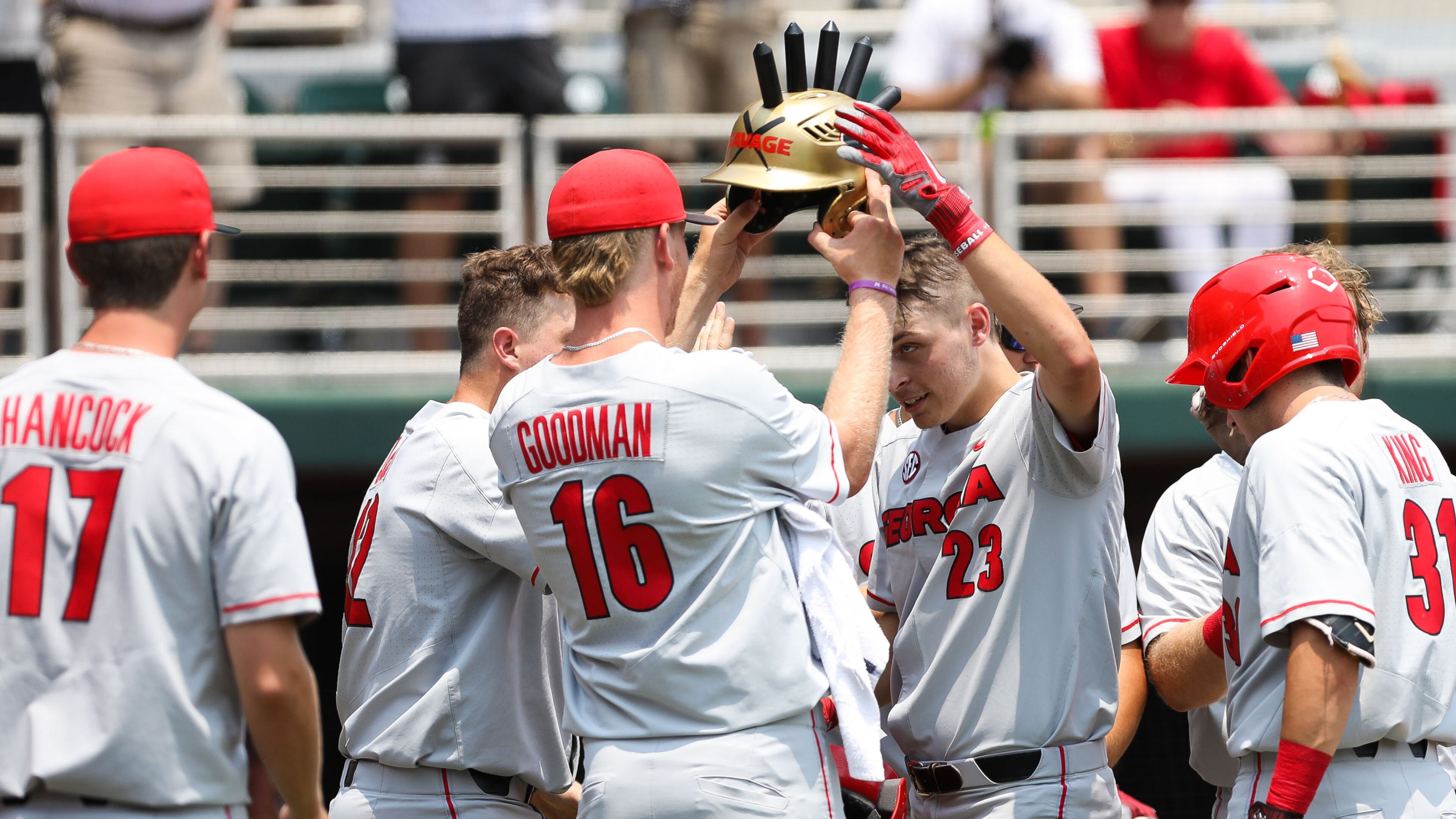 Georgia outfielder Connor Tate (23) is given the "Savage Helmet" after hitting a home run during the NCAA regional baseball game against Florida Atlantic Sunday, June 2, 2019, at Foley Field in Athens.