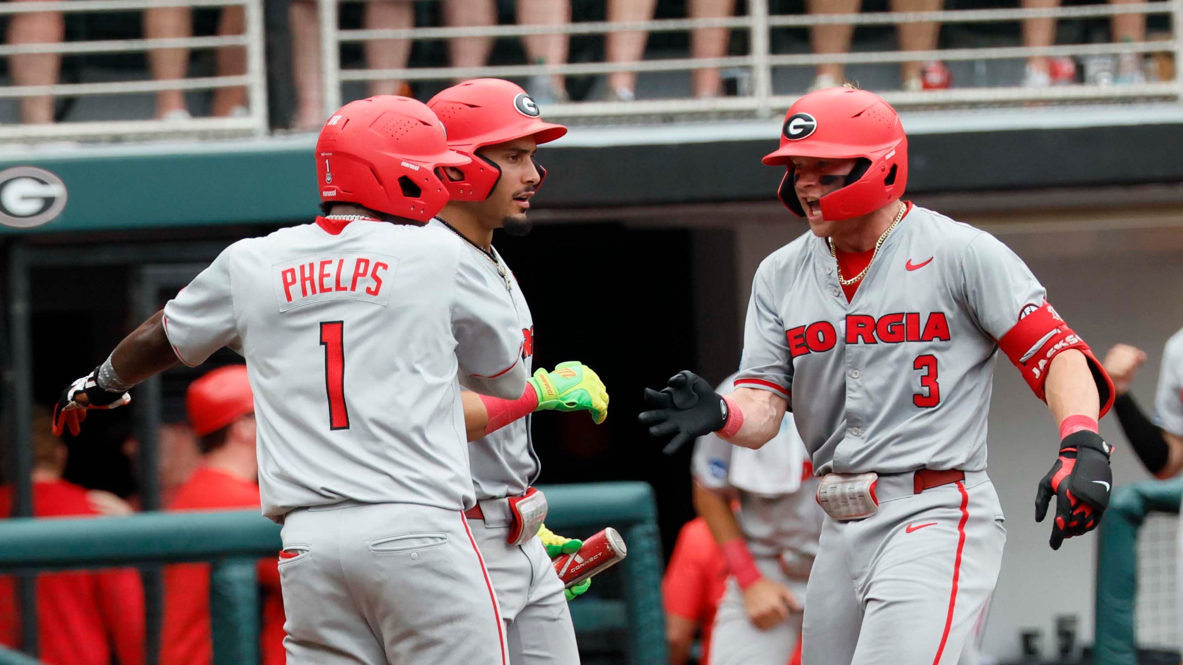 Georgia Bulldogs catcher Daniel Jackson is greeted by infielder Tre Phelps at home plate after hitting a two-run homer to give the team the lead in Game 2 of the NCAA Super Regional on June 7, 2026. (Miguel Martinez/AJC)