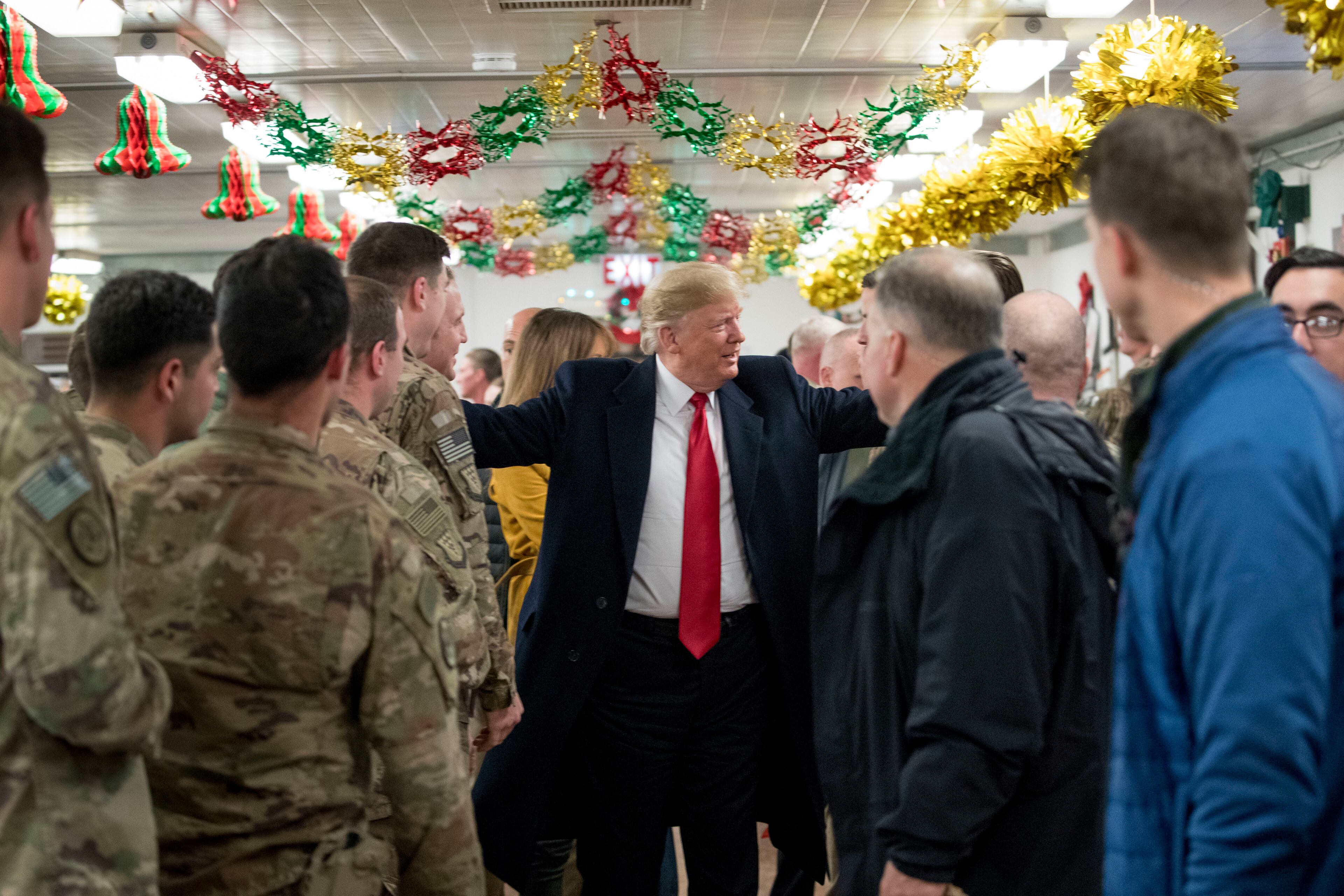 President Donald Trump visits with members of the military at a dining hall at Al Asad Air Base, Iraq, Wednesday, Dec. 26, 2018. (AP Photo/Andrew Harnik)