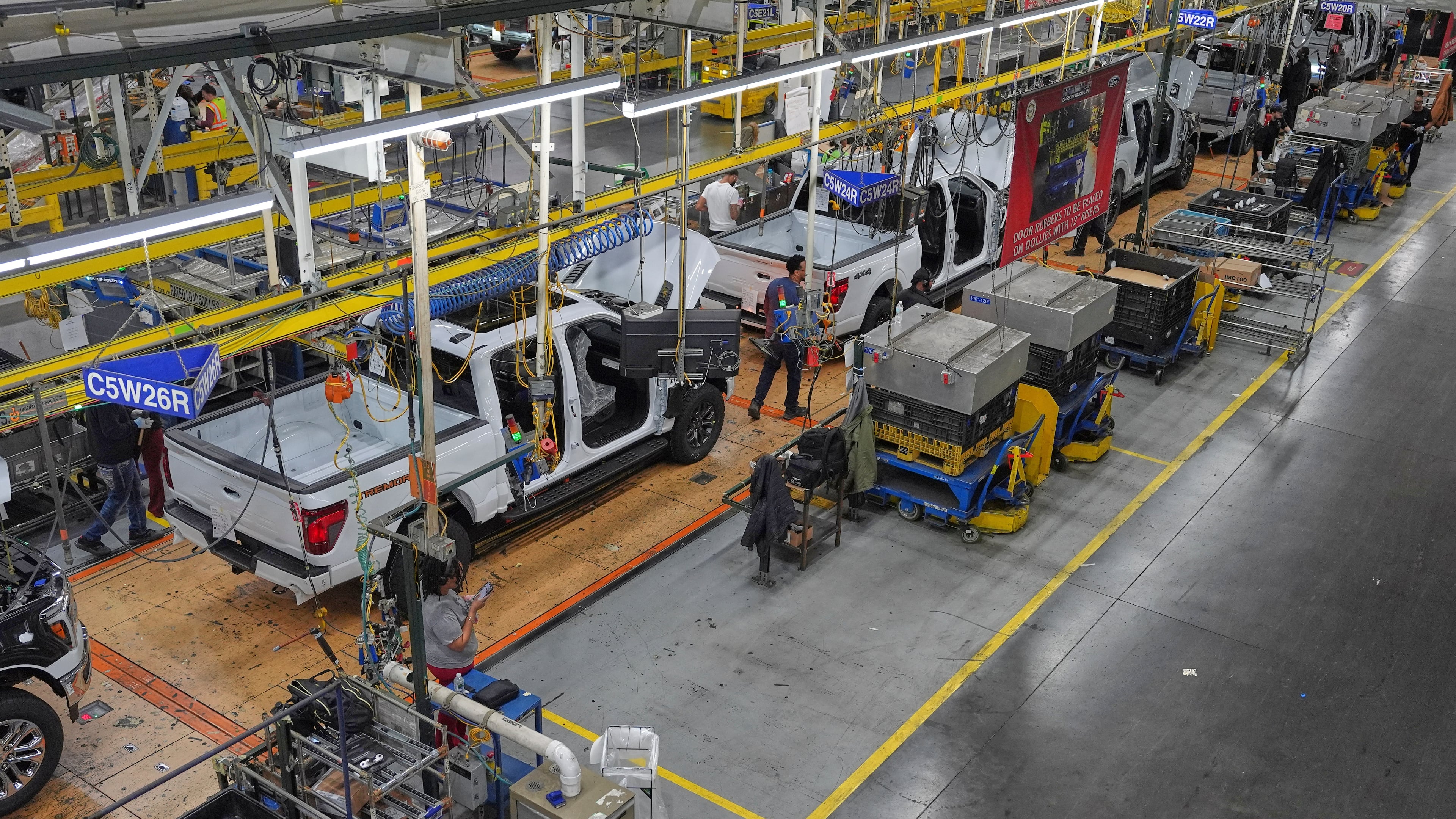 Employees work on the assembly line at the Ford River Rogue complex, Tuesday, Jan. 13, 2026, in Dearborn, Mich. (AP Photo/Evan Vucci)