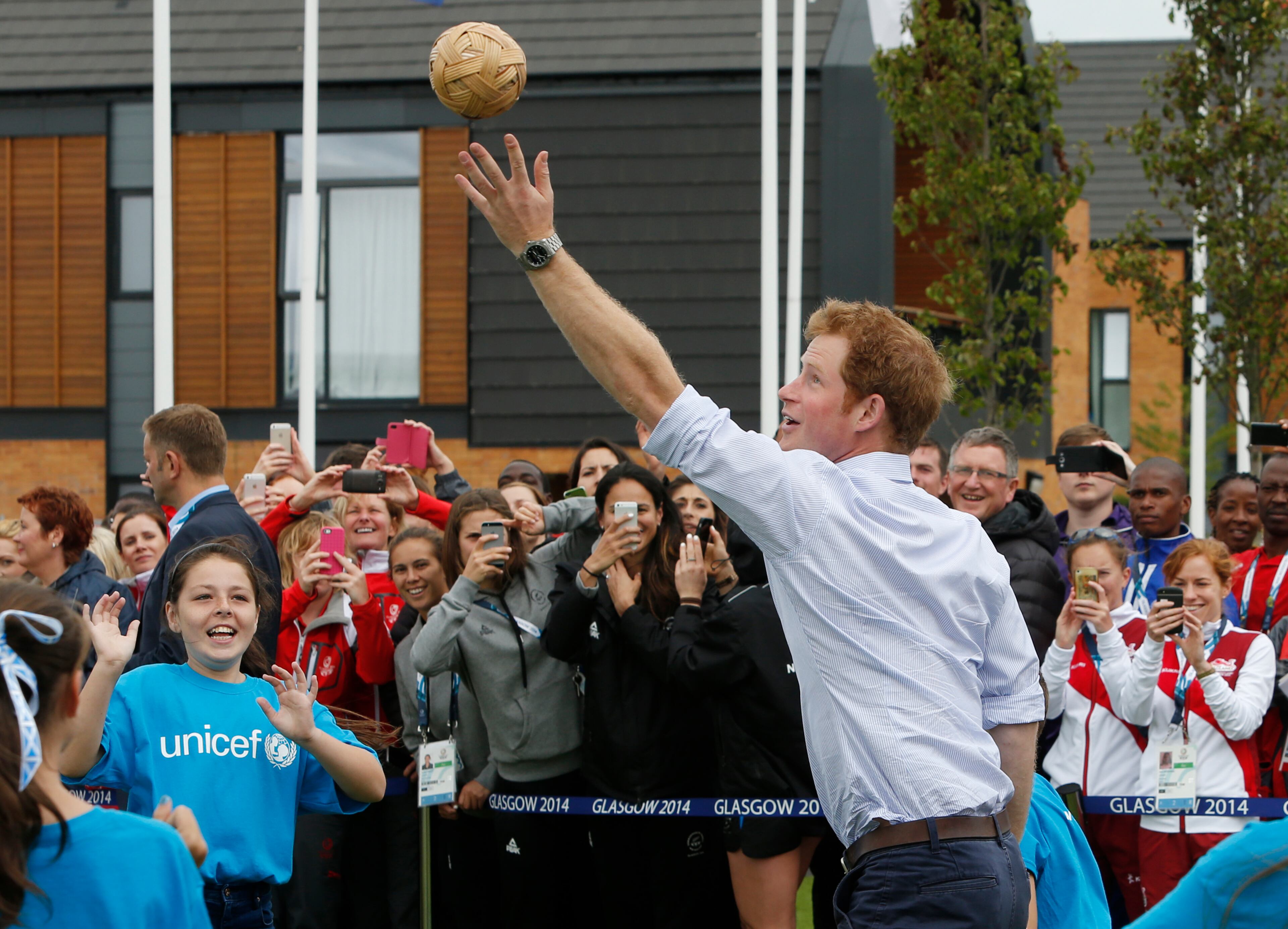 GLASGOW, SCOTLAND - JULY 29: Prince Harry plays a game during a visit to the Commonwealth Games Village on July 29, 2014 in Glasgow, Scotland. (Photo by Danny Lawson - WPA Pool / Getty Images)