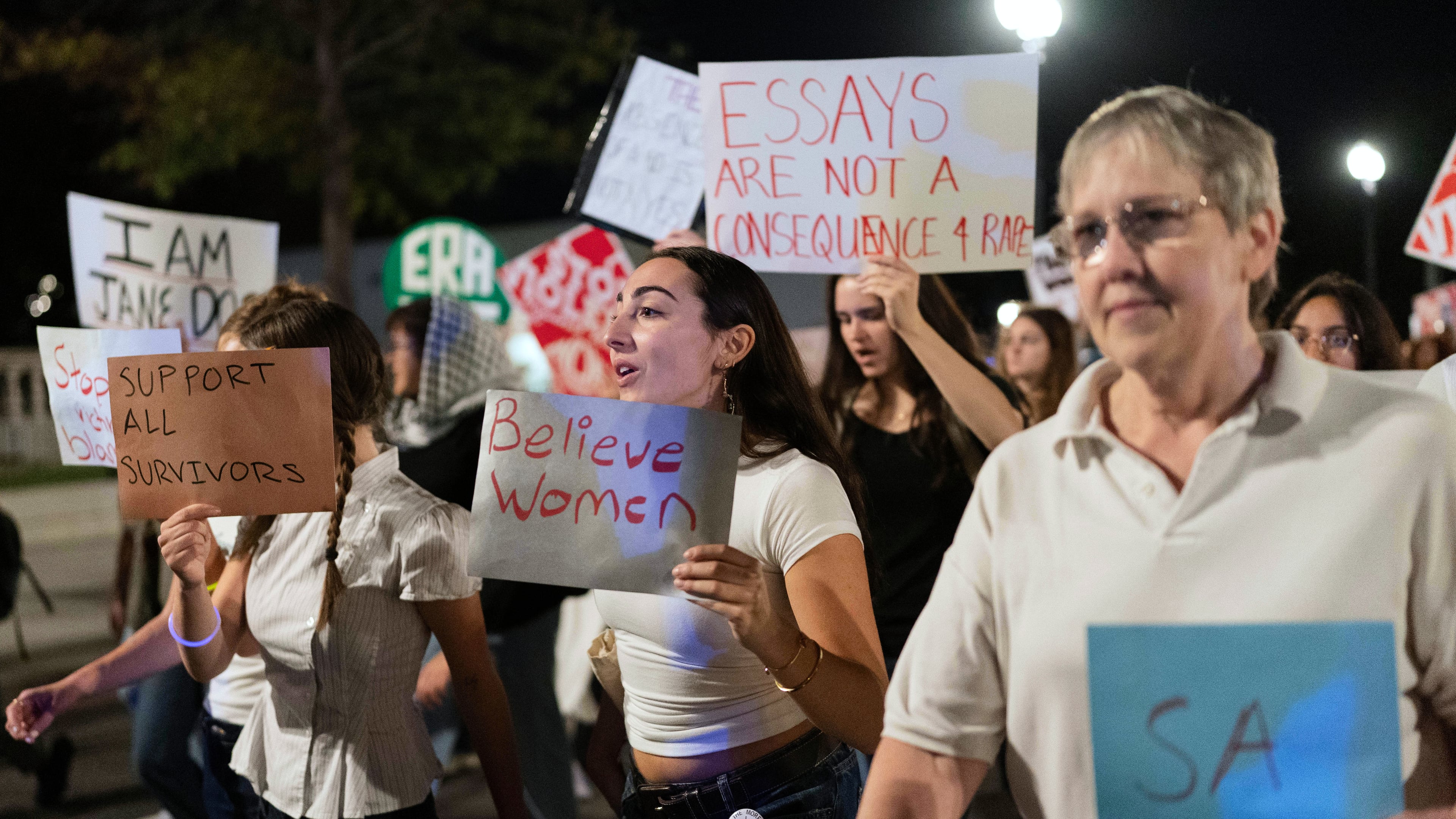 Demonstrators march from the Washington Monument to the White House during a "Stop Sexual Violence" protest in Washington, Thursday, Oct. 8, 2026. (AP Photo/Jose Luis Magana)