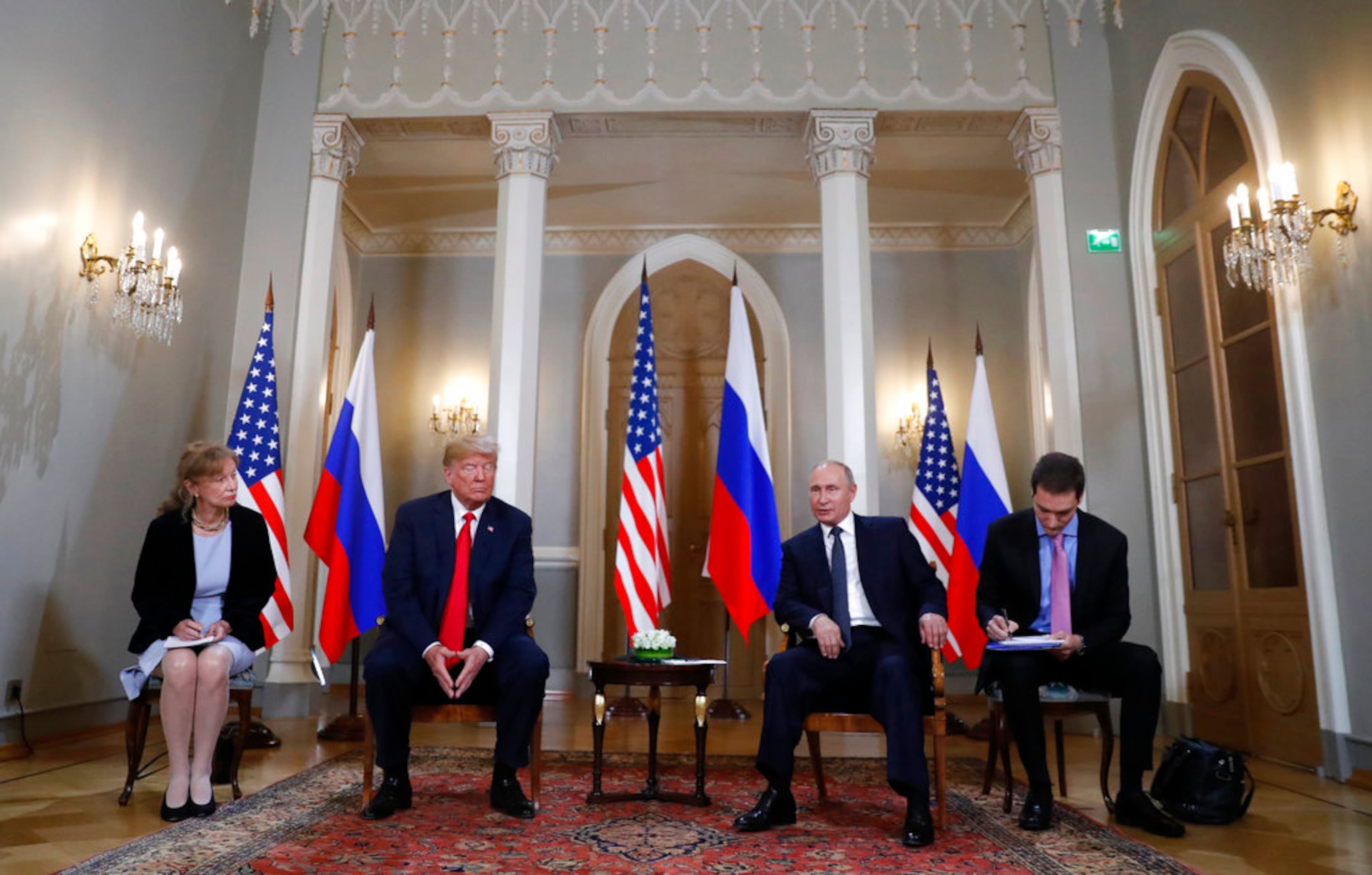 U.S. President Donald Trump, second from left, listens to a statement of Russian President Vladimir Putin, second from right, at the beginning of a meeting at the Presidential Palace in Helsinki, Finland, Monday, July 16, 2018. (AP Photo/Pablo Martinez Monsivais)