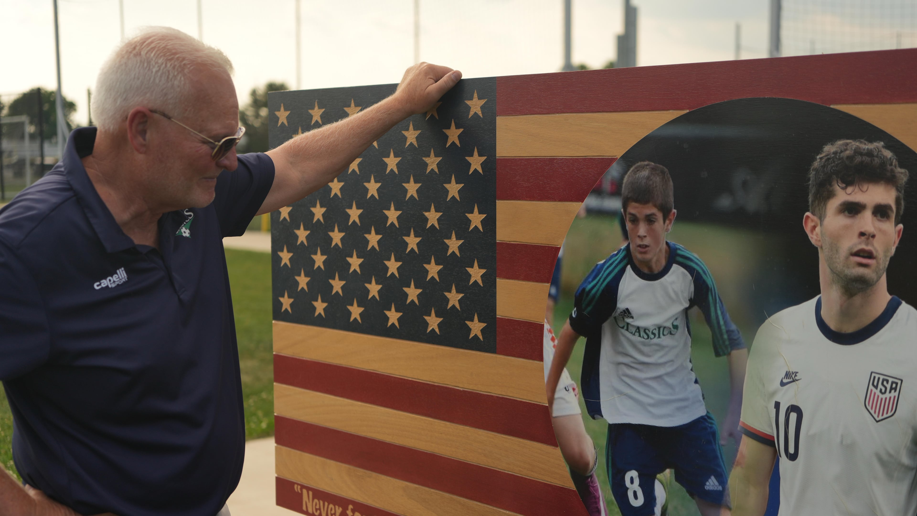 Pennsylvania Classic co-founder and president, Doug Harris, looks at a banner of U.S. national team soccer player, Christian Pulisic, who was born in nearby Hershey, and honed his skills at the club in Manheim, Pa., on Monday, June 29, 2026. (AP Photo/Luis Andres Henao)