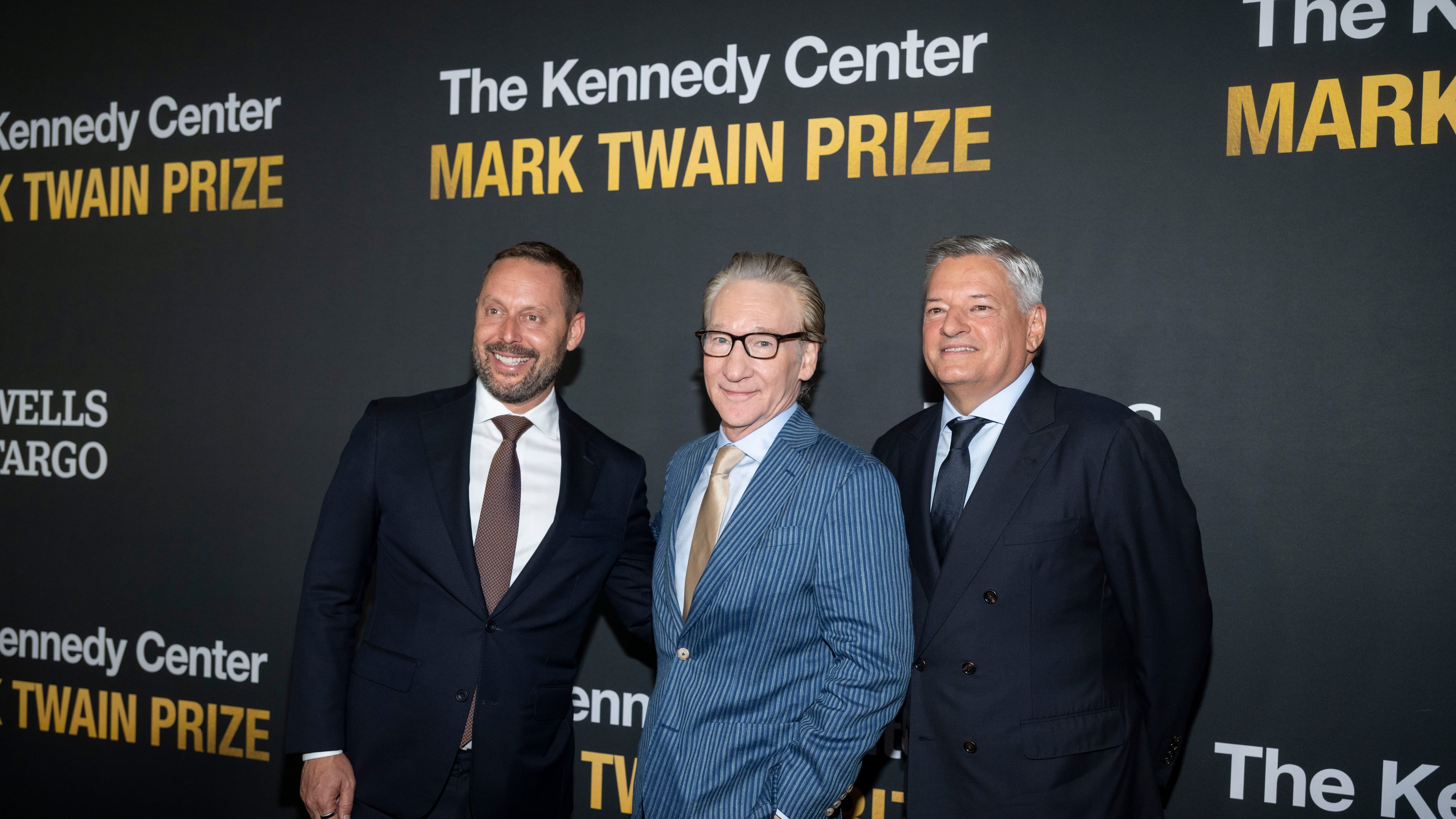 From left, Michael Kives, Comedian and political satirist Bill Maher, and Ted Sarandos pose on the red carpet for the 27th Annual Mark Twain Prize for American Humor Celebrating Bill Maher, Sunday, June 29, 2026, in Washington. (AP Photo/Kevin Wolf)