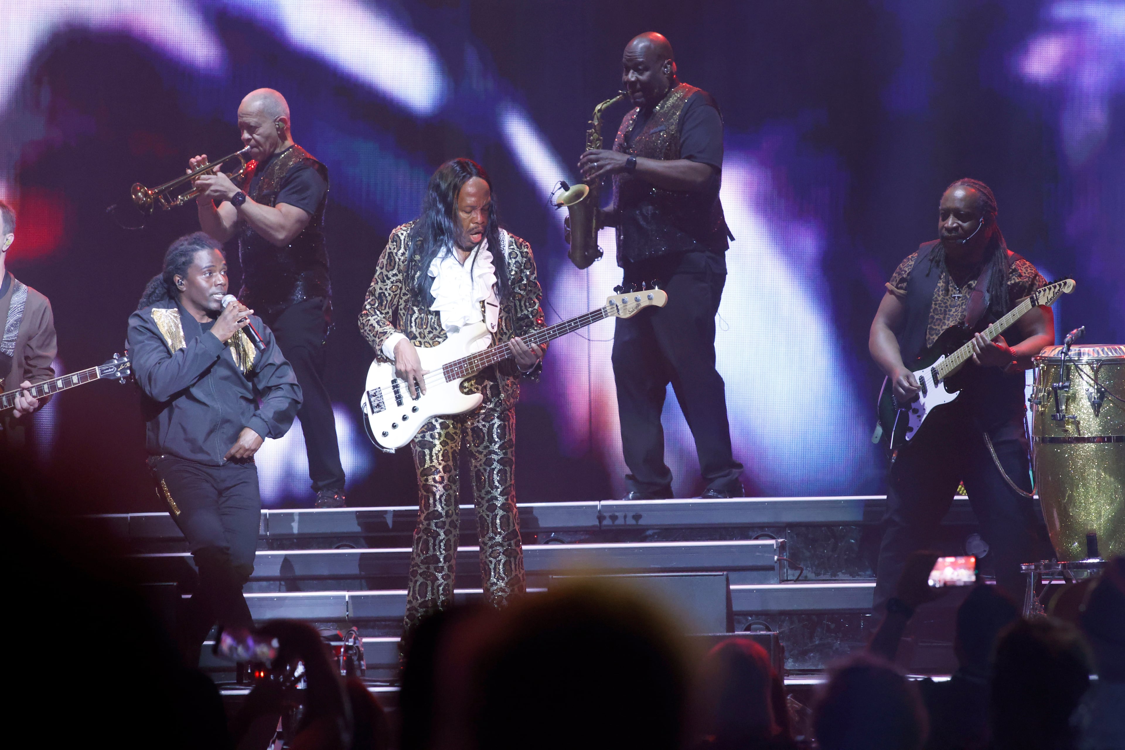 The iconic Earth, Wind & Fire perform at State Farm Arena on Sunday, July 19, 2026. Verdine White (center), brother to Maurice White, founder of Earth Wind & Fire and one of the last original members, wails on his guitar. (Akili-Casundria Ramsess for the AJC)