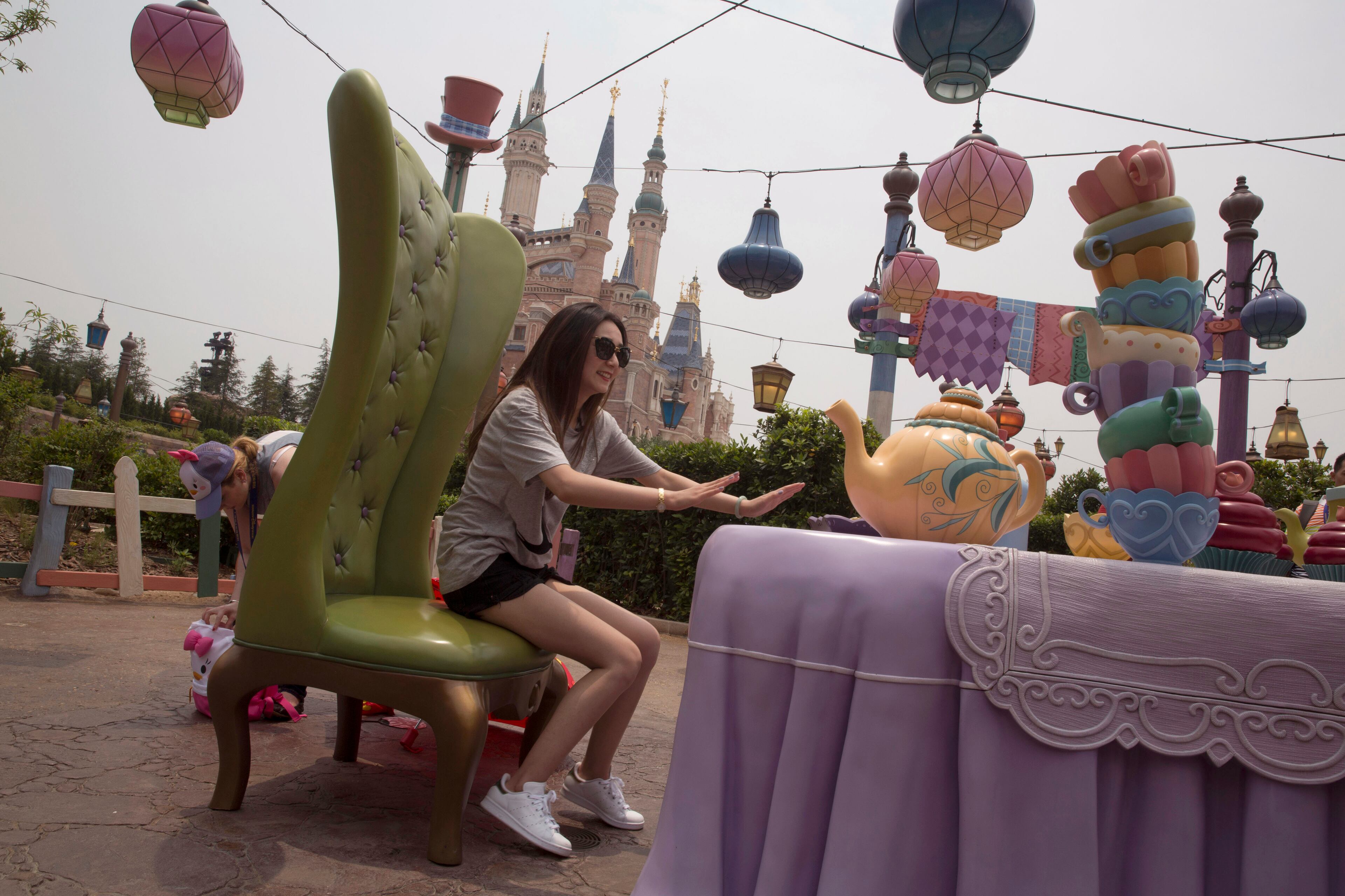A visitor poses for photos at an attraction on the eve of the opening of the Disney Resort in Shanghai, China, Wednesday, June 15, 2016. Disney will open its first resort in mainland China on Thursday. (AP Photo/Ng Han Guan)