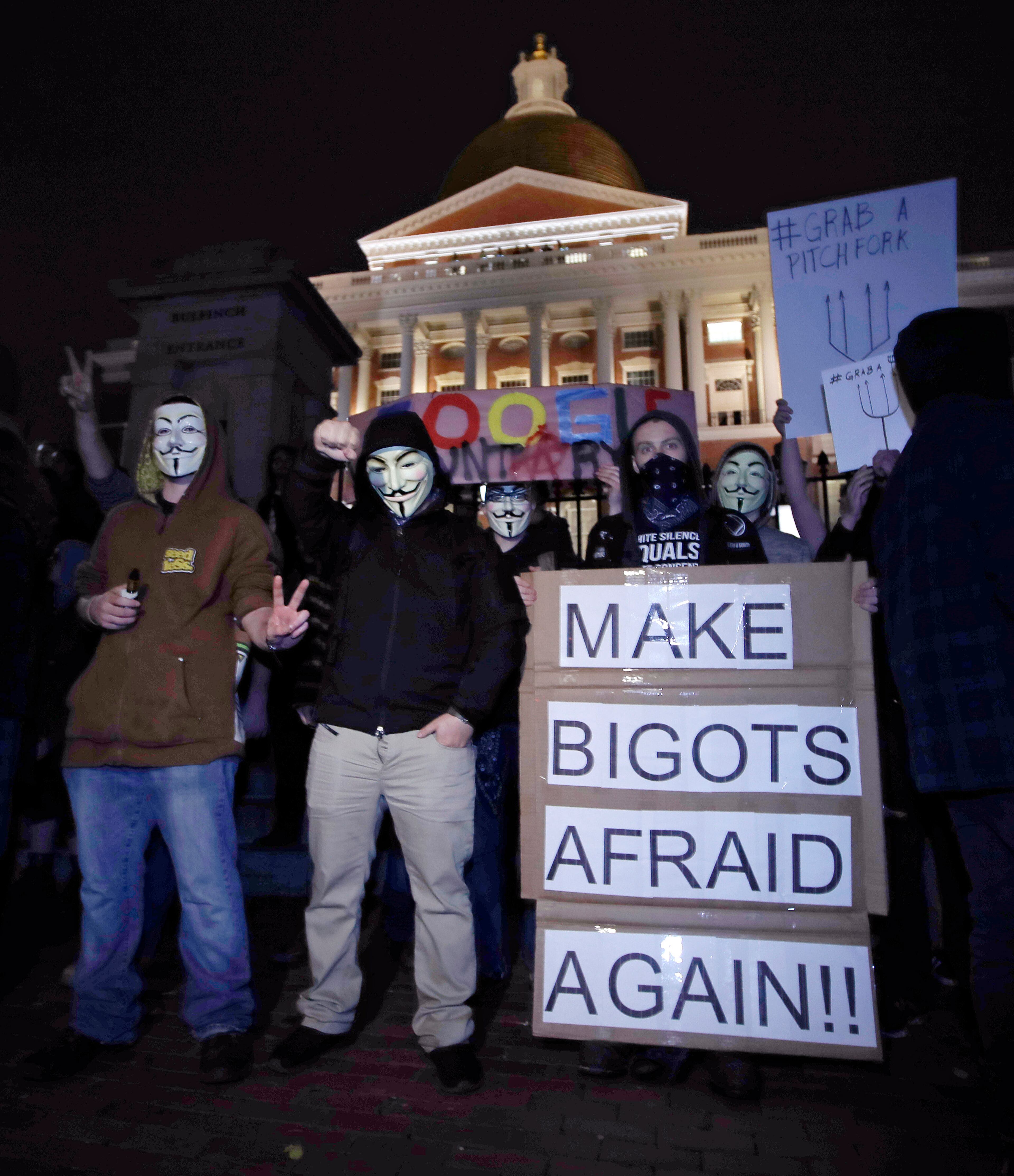 Protesters stand on the Mass. Statehouse steps in opposition of Donald Trump's presidential election victory in Boston, Wednesday evening, Nov. 9, 2016. (AP Photo/Charles Krupa)