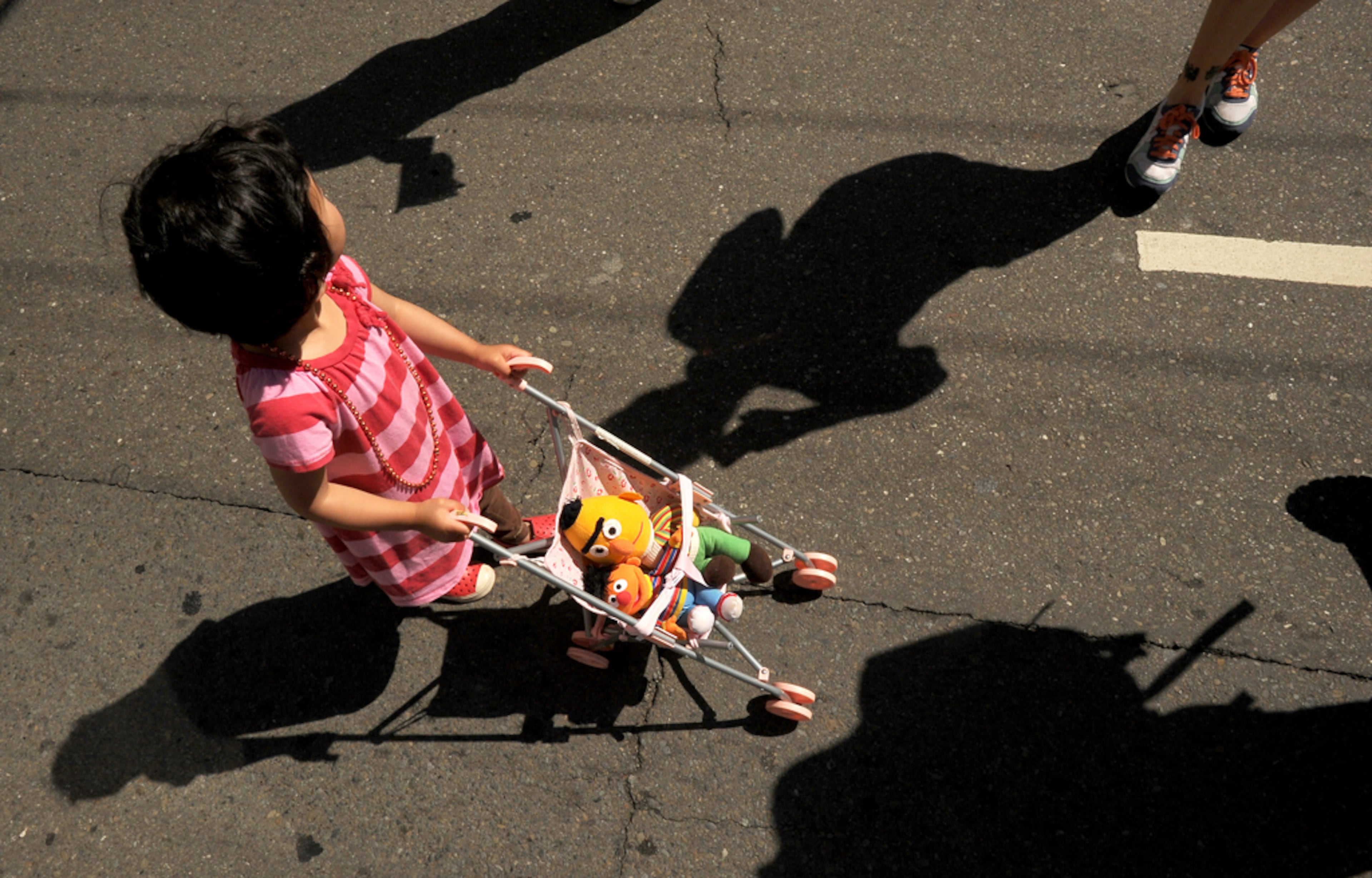 Anisa Alejandrino, 2, pushes Sesame Street characters Bert and Ernie in a stroller while waiting for the start of San Francisco's 43rd annual gay pride parade Sunday, June 30, 2013. (AP Photo/Noah Berger)
