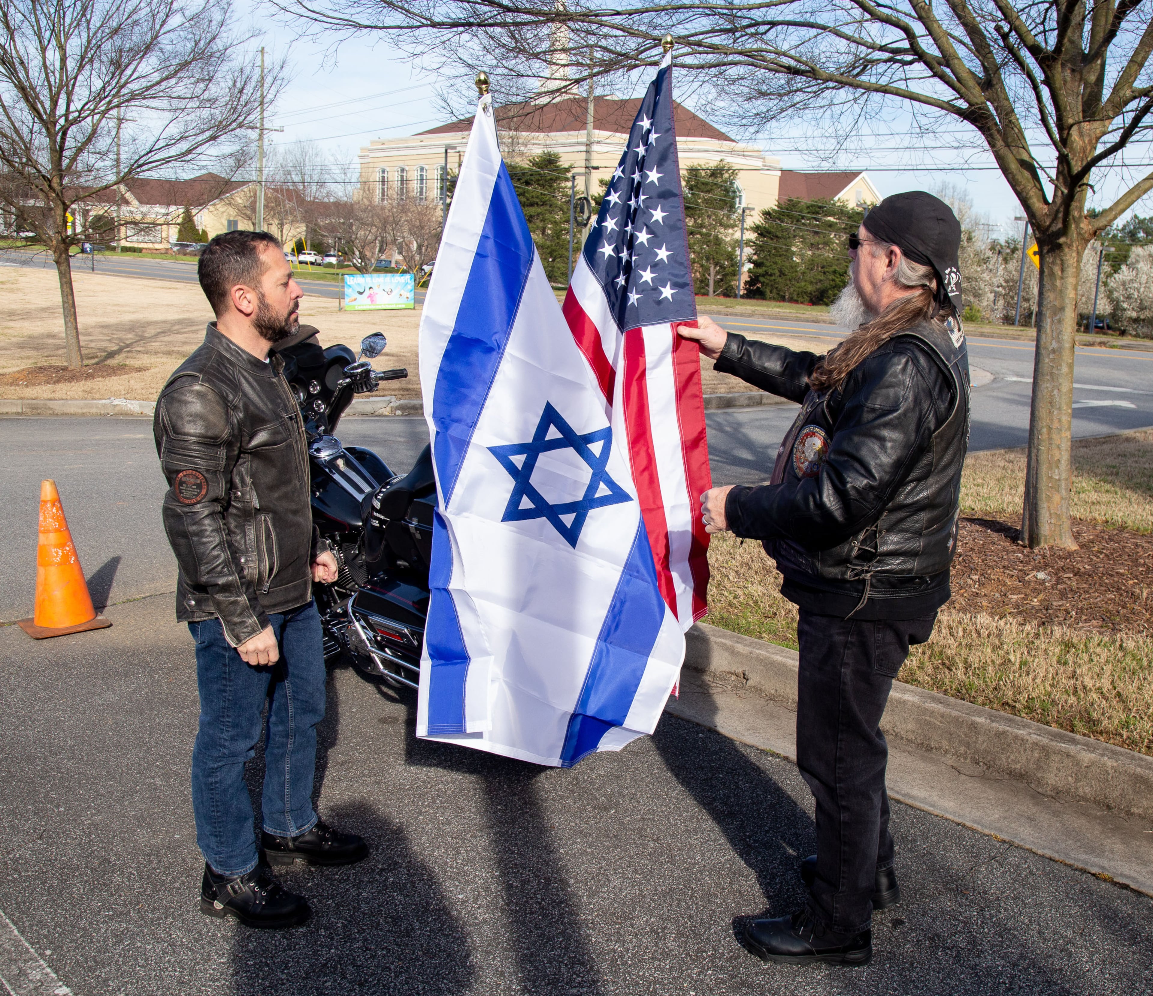 Sabra Rider's Joel Rapowitz (L) and Wayne Markman get Markman's motorcycle ready for the parade before the start of the celebration for the completion of the historic Torah scroll at the Chabad of Cobb Sunday, March 8, 2020. STEVE SCHAEFER / SPECIAL TO THE AJC