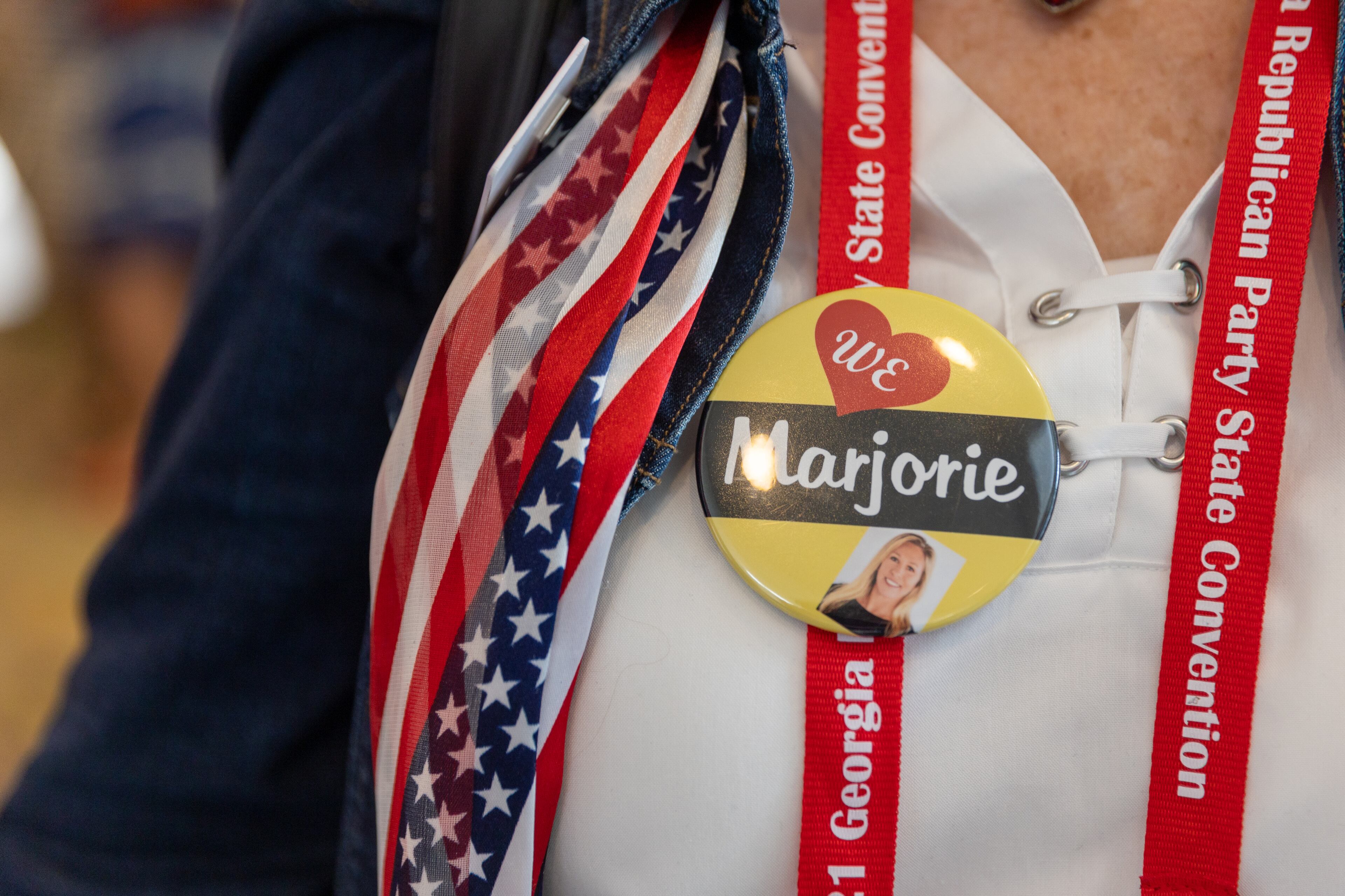 A woman hands out "We love Marjorie" pins at the Georgia GOP convention at Jekyll Island on Saturday, June 5, 2021. (Photo: Nathan Posner for The Atlanta-Journal-Constitution)