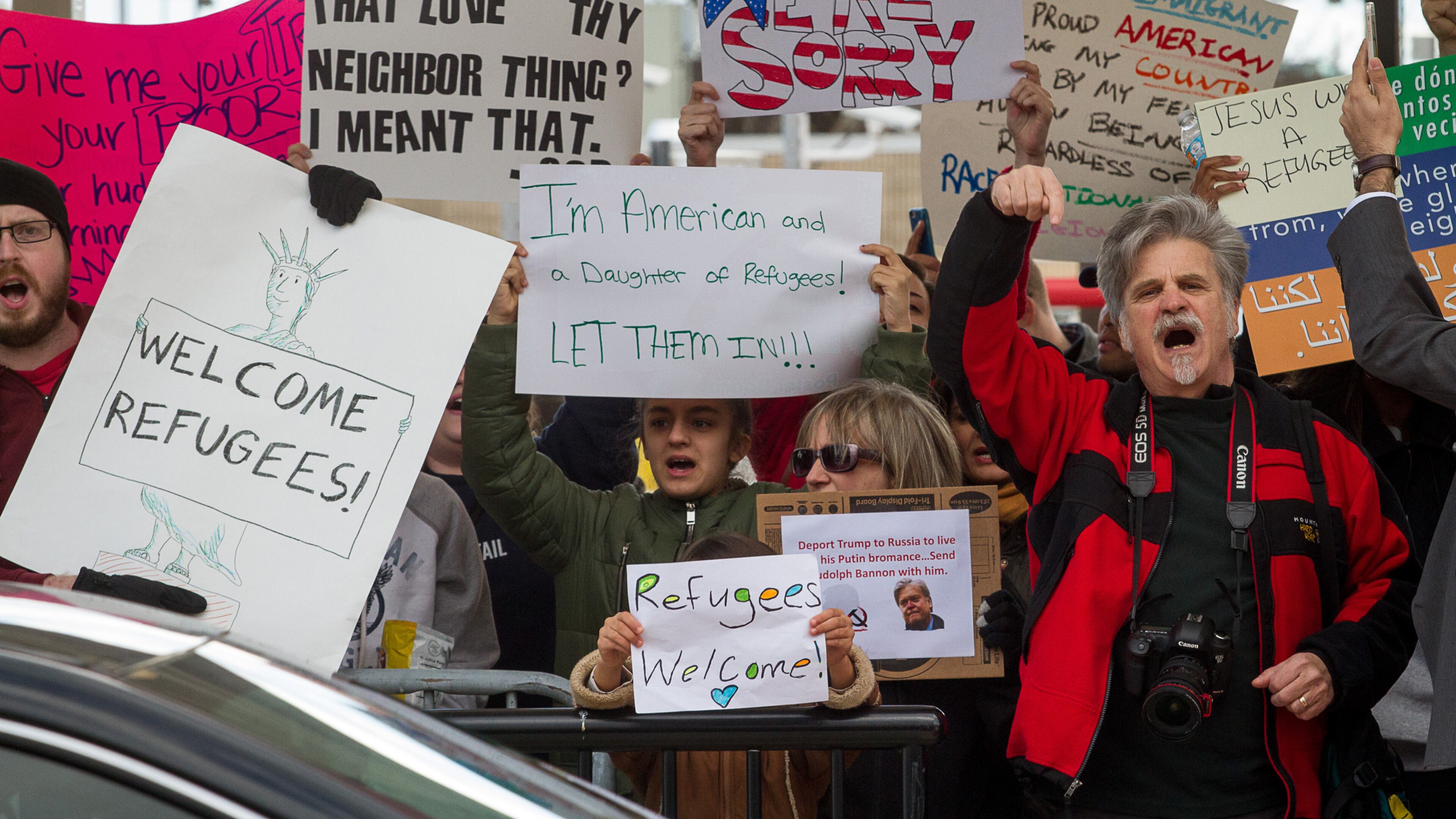 Protesters hold up signs during a demonstration against President Trump's recent travel ban on Sunday at Hartsfield-Jackson Atlanta International Airport. Steve Schaefer/Special to the AJC