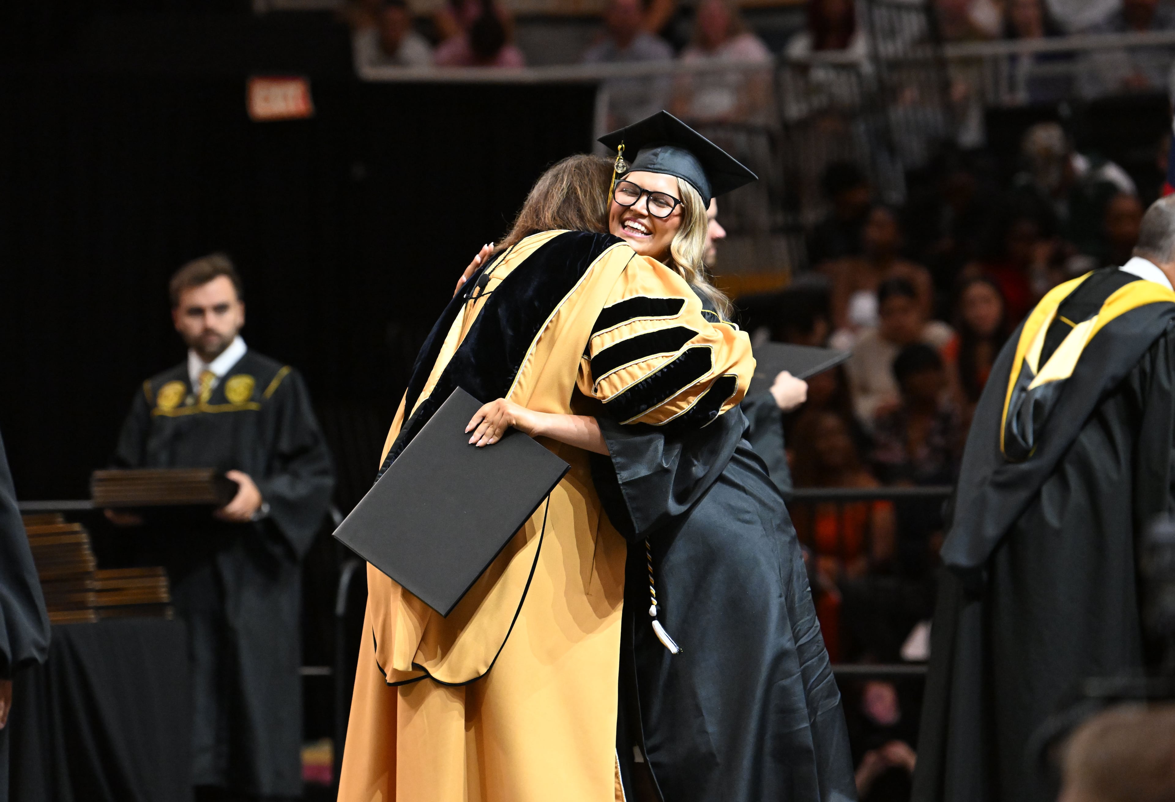 Did you hug the person who handed you your college diploma? This KSU graduate did. (Hyosub Shin/AJC)