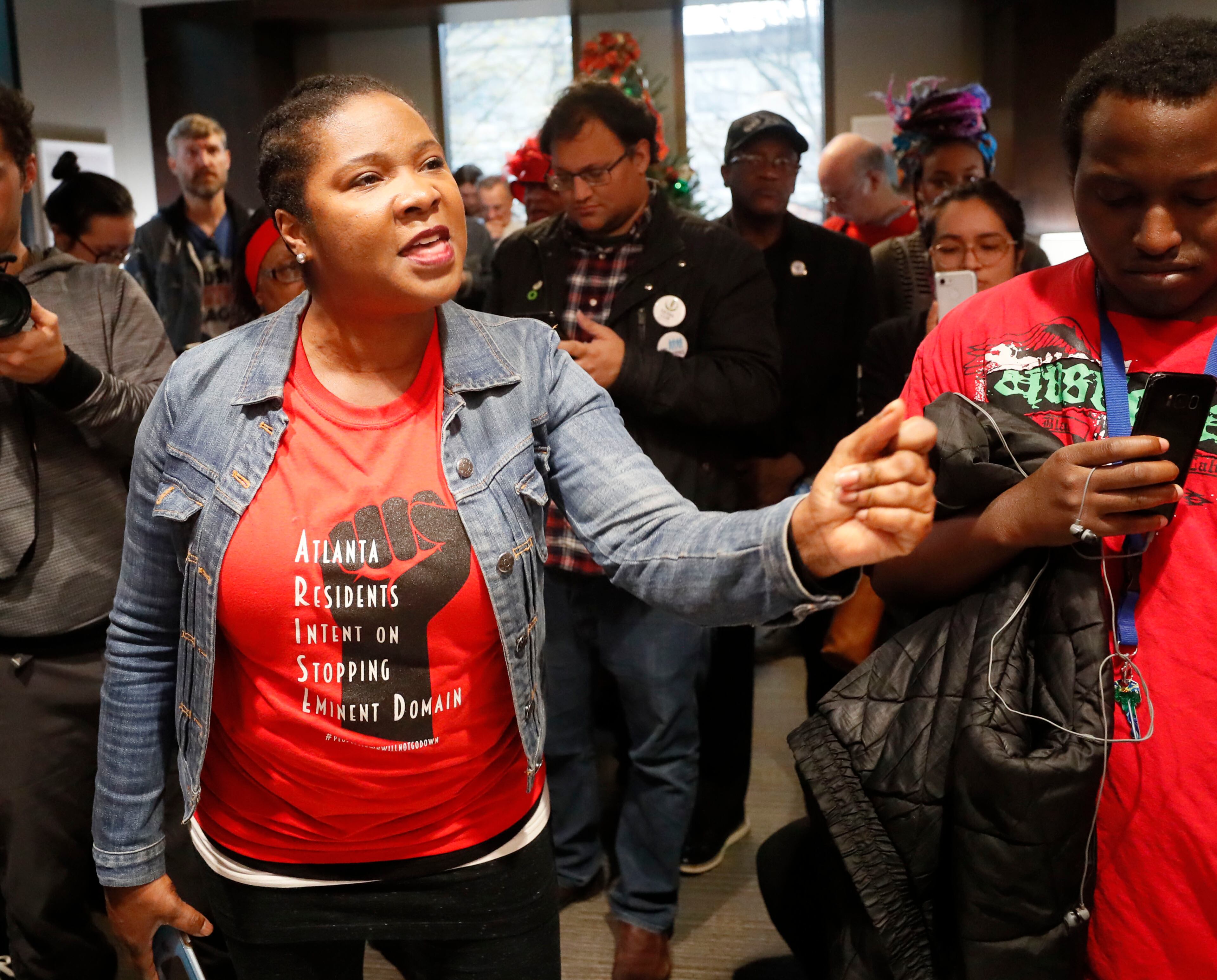 Tanya Washington, who joined other Peoplestown residents in a legal battle to try to keep their homes, talks with Rashad Taylor (not in photo), a senior adviser to Mayor Keisha Lance Bottoms, as she joined others in occupying the reception area of the mayor's office. The Housing Justice League held a rally at City Hall and a sit-in at the Mayor's Office on December 16, 2019. The protesters want Atlanta Mayor Keisha Lance Bottoms to let Peoplestown residents in the city stay in their homes and not be displaced by eminent domain to build a park and retention pond. Bob Andres / bandres@ajc.com