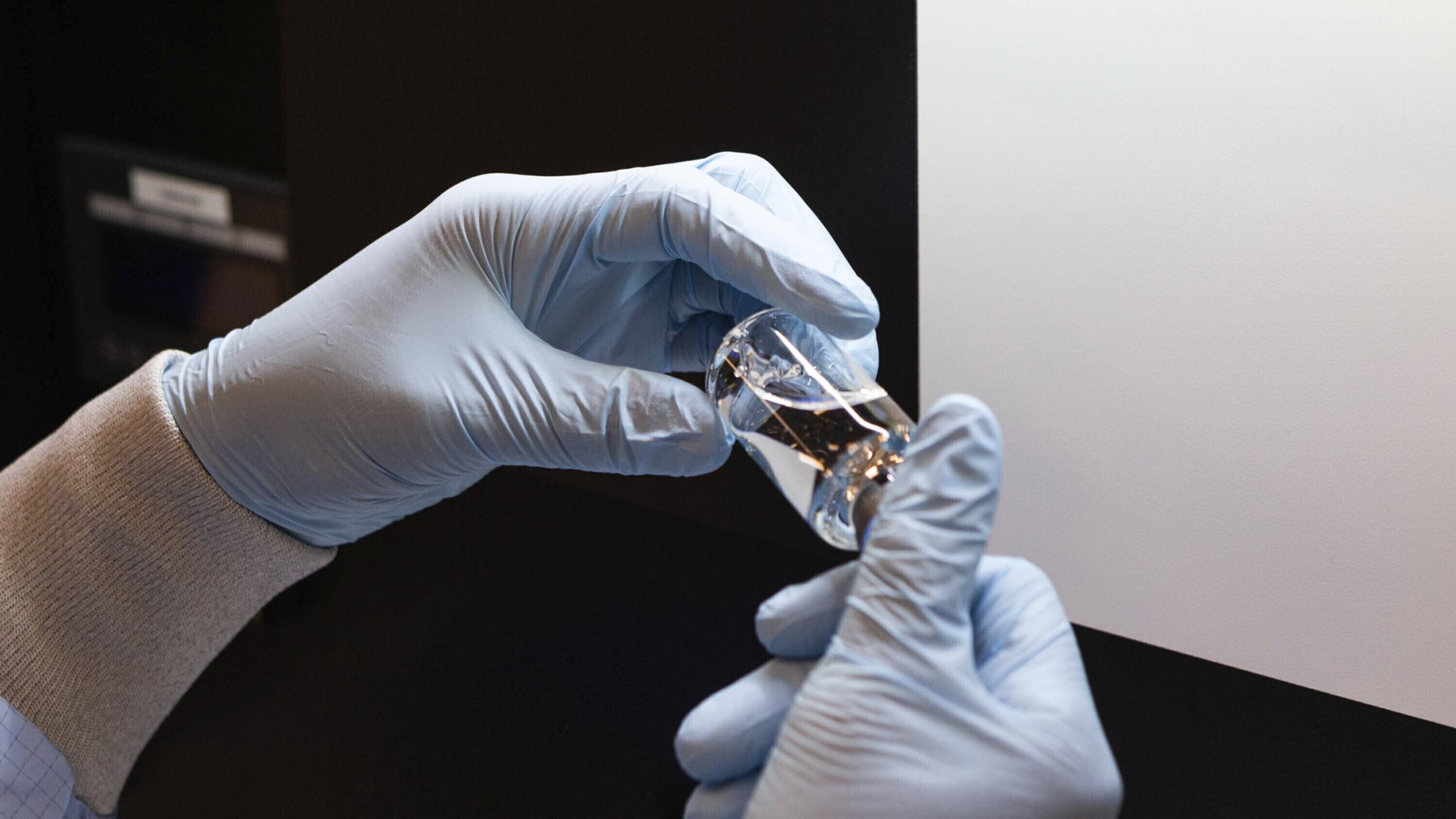 In this March 2020 photo provided by Gilead Sciences, a vial of the investigational drug remdesivir is visually inspected at a Gilead manufacturing site in the United States. Given through an IV, the medication is designed to interfere with an enzyme that reproduces viral genetic material. (Gilead Sciences via AP)