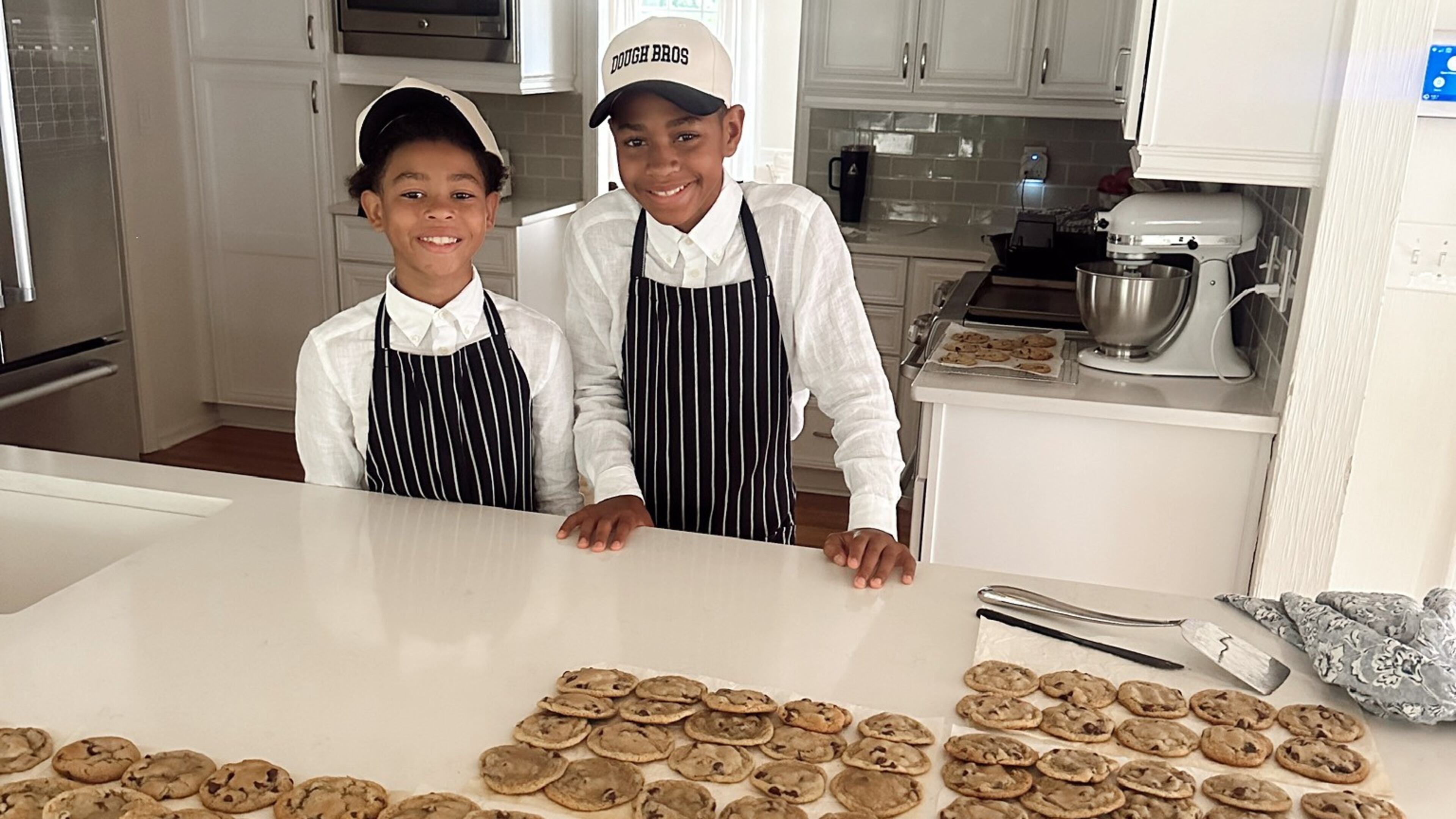 The Lampley brothers, Leo (left), 8, and London, 11, have made hundreds of cookies, muffins and loaves of bread to sell at their summer bakery stand, Dough Bros. The hard-working brothers had a lemonade and juice stand and a car washing business before this latest venture. (Courtesy of Sarah Lampley)