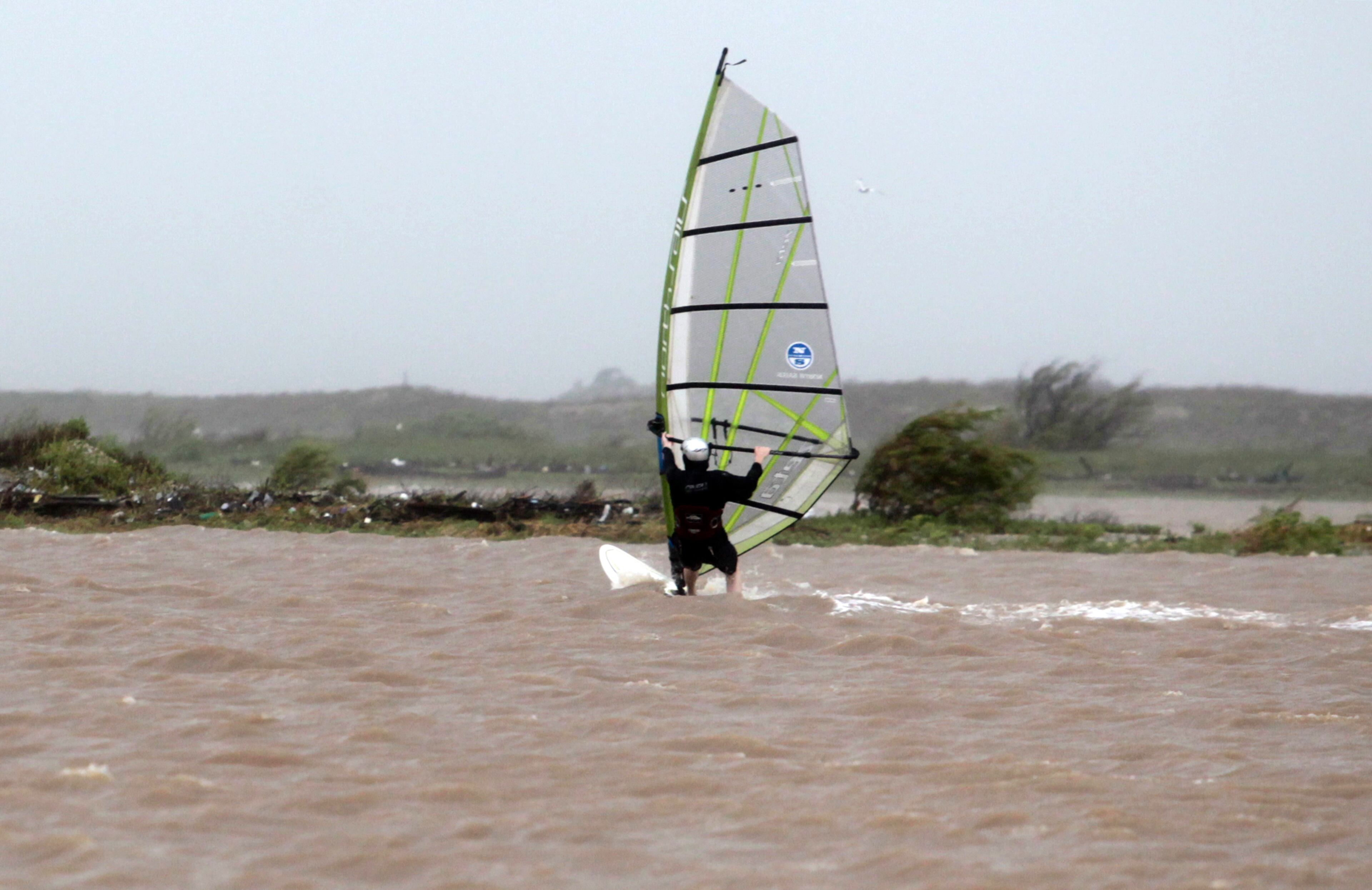 A wind surfer who wished to remain anonymous surfs the choppy waves that Tropical Storm Bill brought to shore on Tuesday, June 16, 2015, in Matagorda, Texas. Southeastern Texas is expected to see between 4 and 8 inches of rain by the end of Wednesday, with some areas getting as much as 12 inches. (AP Photo/Patric Schneider)