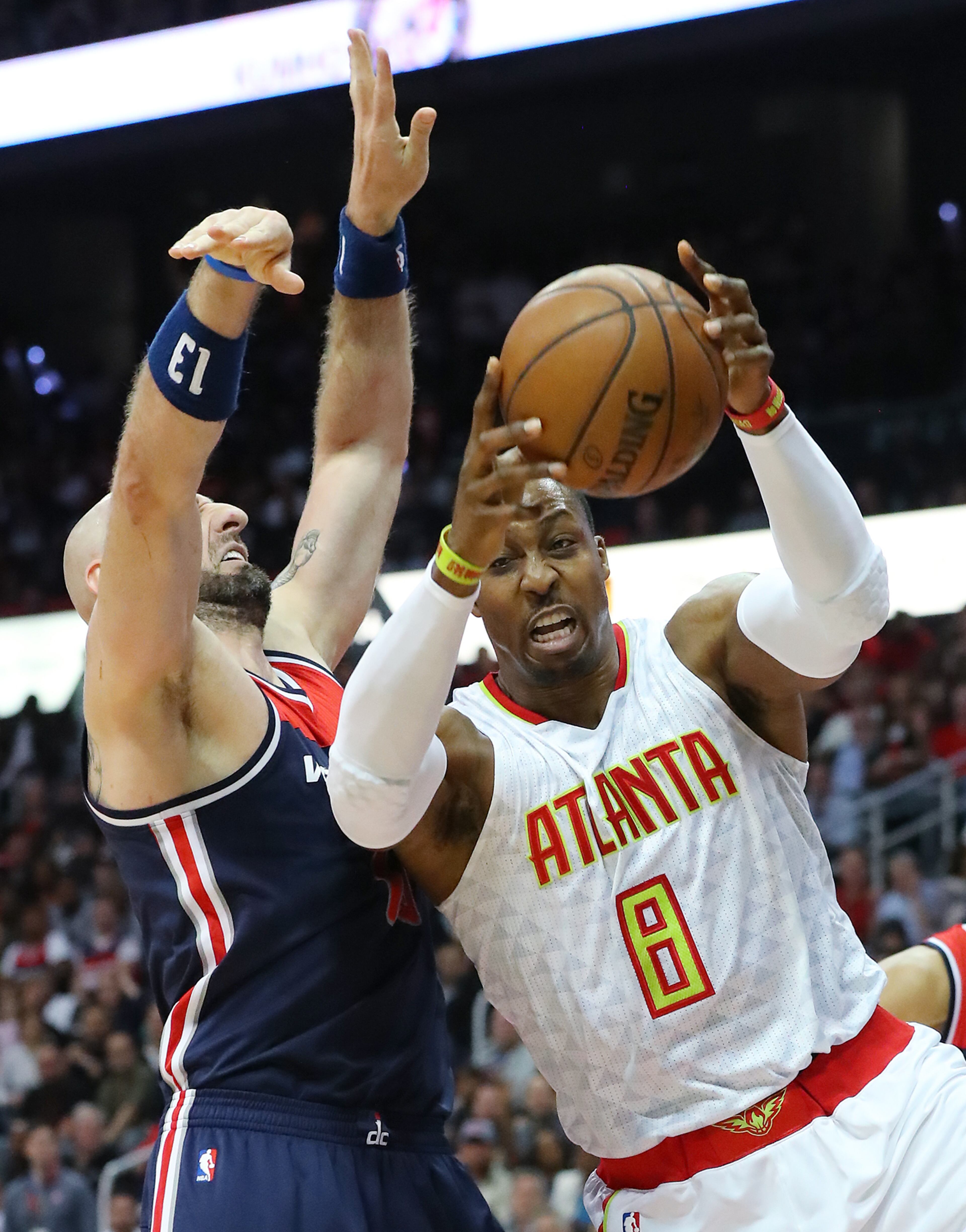 Dwight Howard battles Marcin Gortat for a rebound in game 4 of a first-round NBA basketball playoff series on Monday, April 24, 2017, in Atlanta.