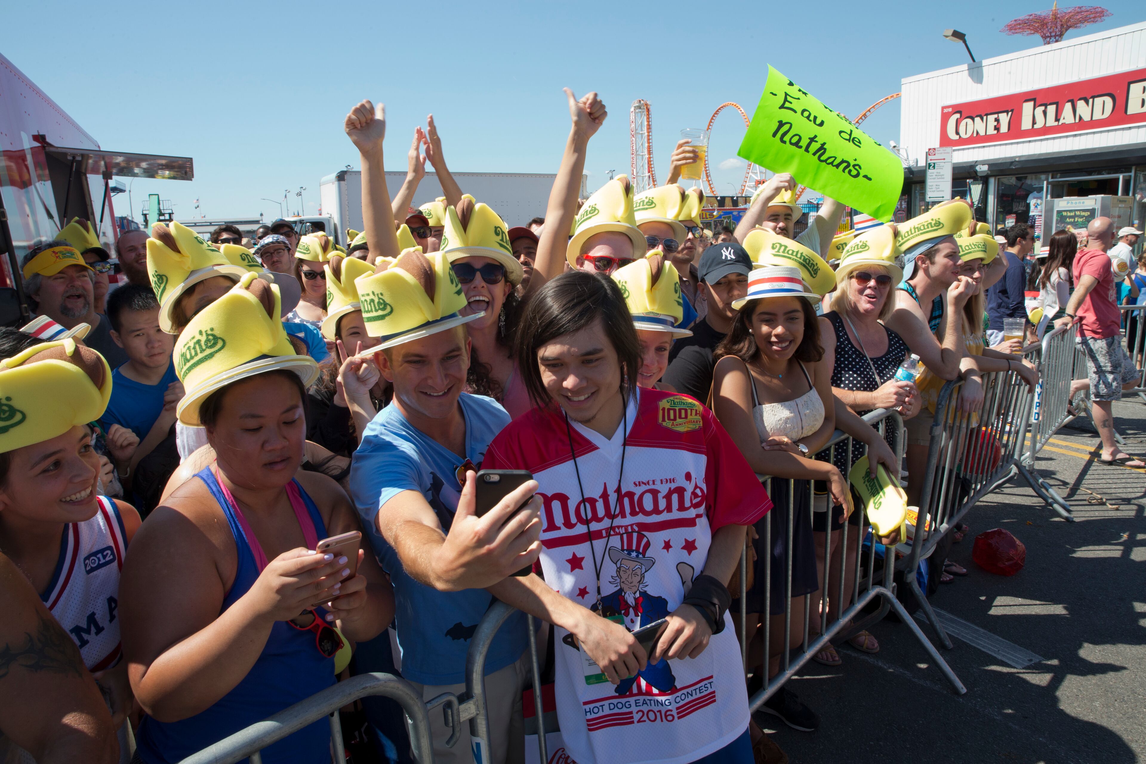 Matt Stonie, reigning hot dog-eating champion, poses for a selfie with a fan before competing in Nathan's Famous Fourth of July International Hot Dog Eating Contest, Monday, July 4, 2016, in New York. (AP Photo/Mary Altaffer)