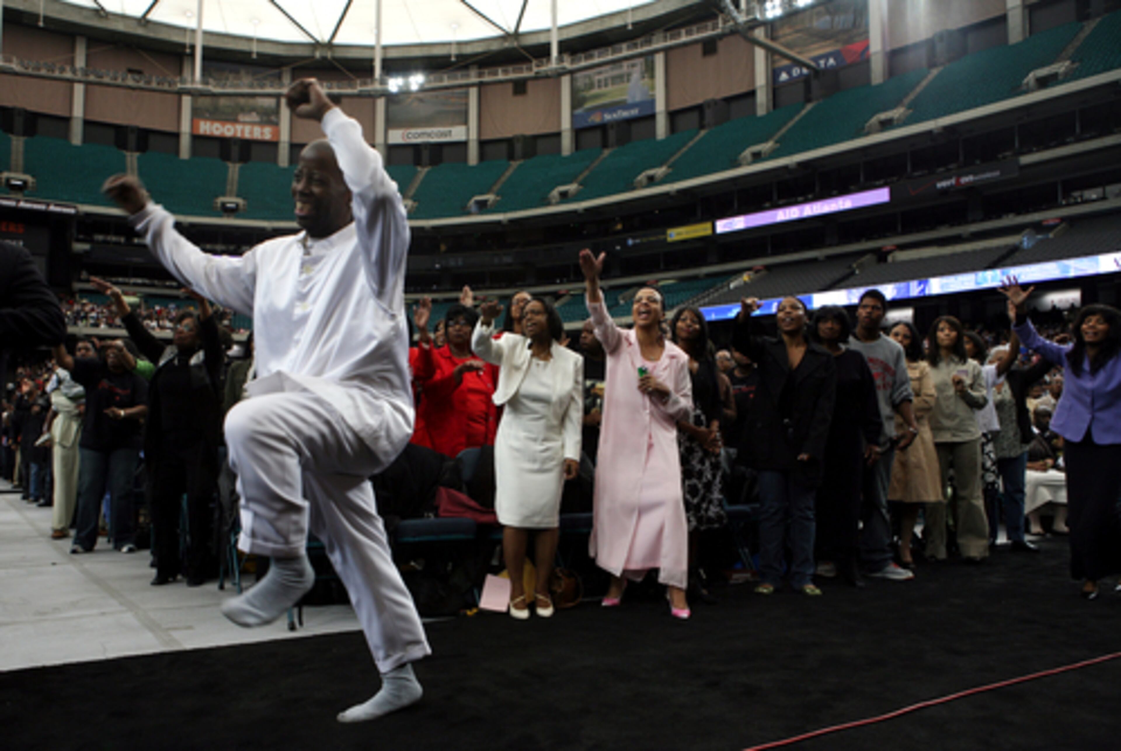 Worshipper Dar'rell Gibron of Atlanta jumps with excitement during New Birth Missionary Baptist Church's Easter service.