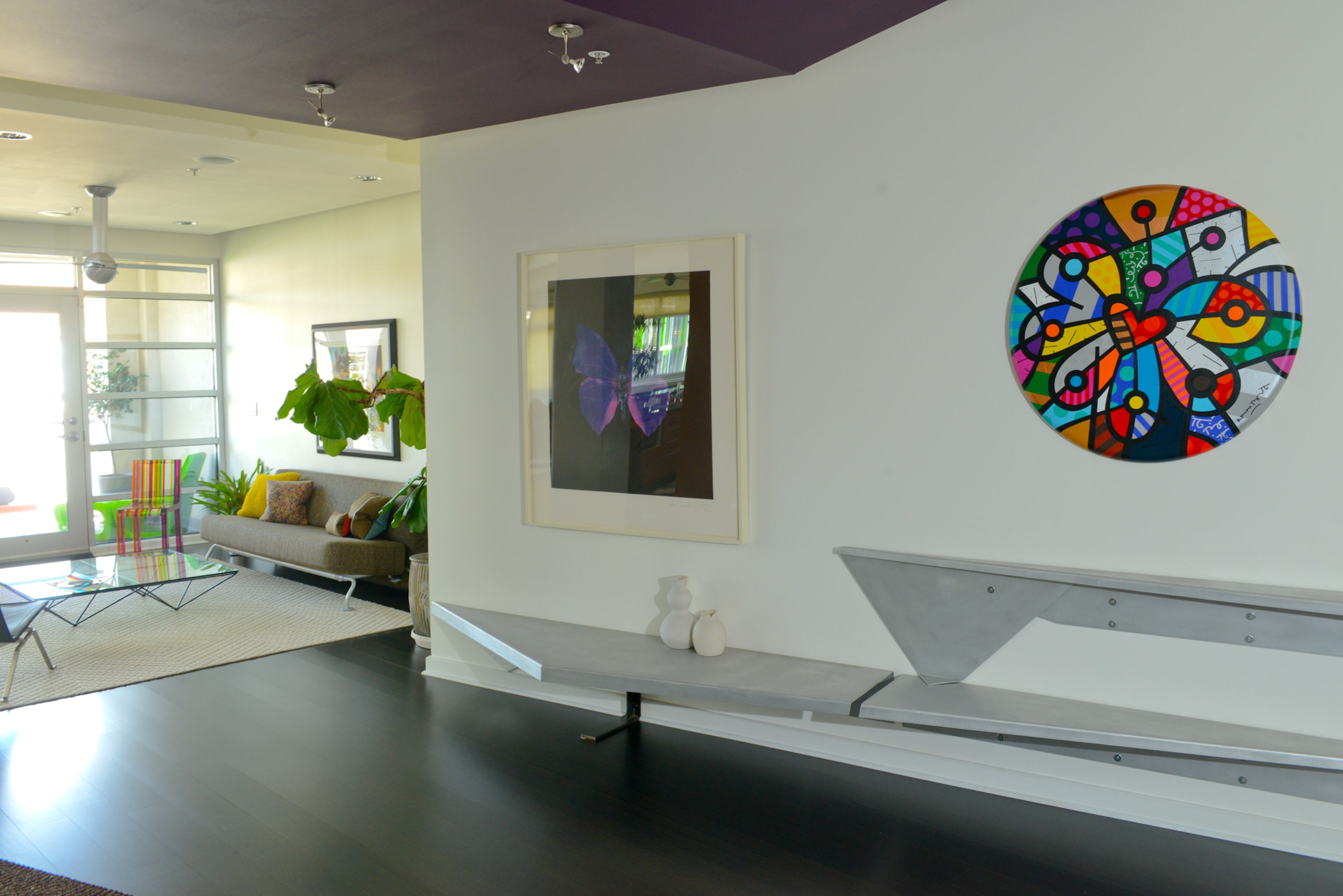 The walls, painted Behr's Whisper White, in David and Cindi Oakey's Atlanta loft provide a blank canvas to showcase their houseful of vibrant art, including pieces from Miami-based Romero Britto, British artist Damien Hirst and Rolling Stones guitarist Ronnie Wood.