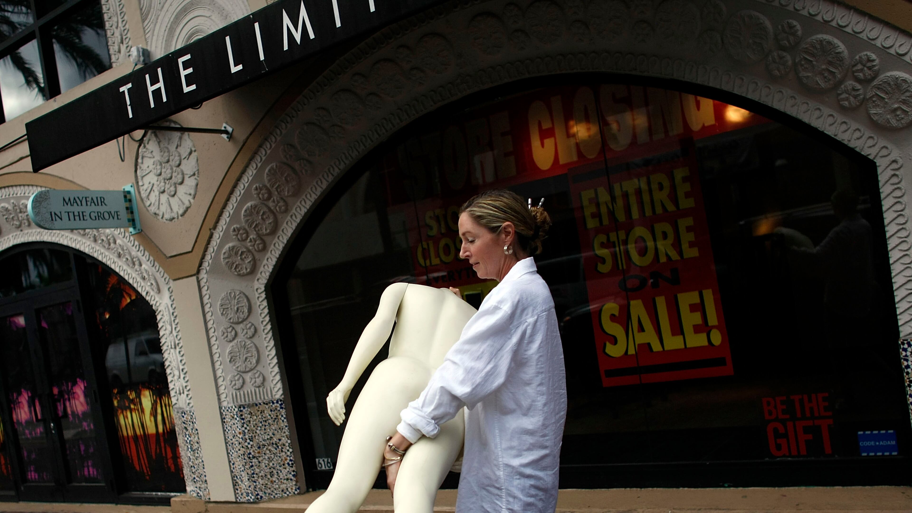 MIAMI - JANUARY 16: Marcie Ziv carries a Mannequin from The Limited store as it closes the location January 16, 2008 in Miami, Florida. Financial reports indicate that shoppers have tightened their belts on spending and manufacturers are seeing weak demand for cars and housing-related goods. (Photo by Joe Raedle/Getty Images)