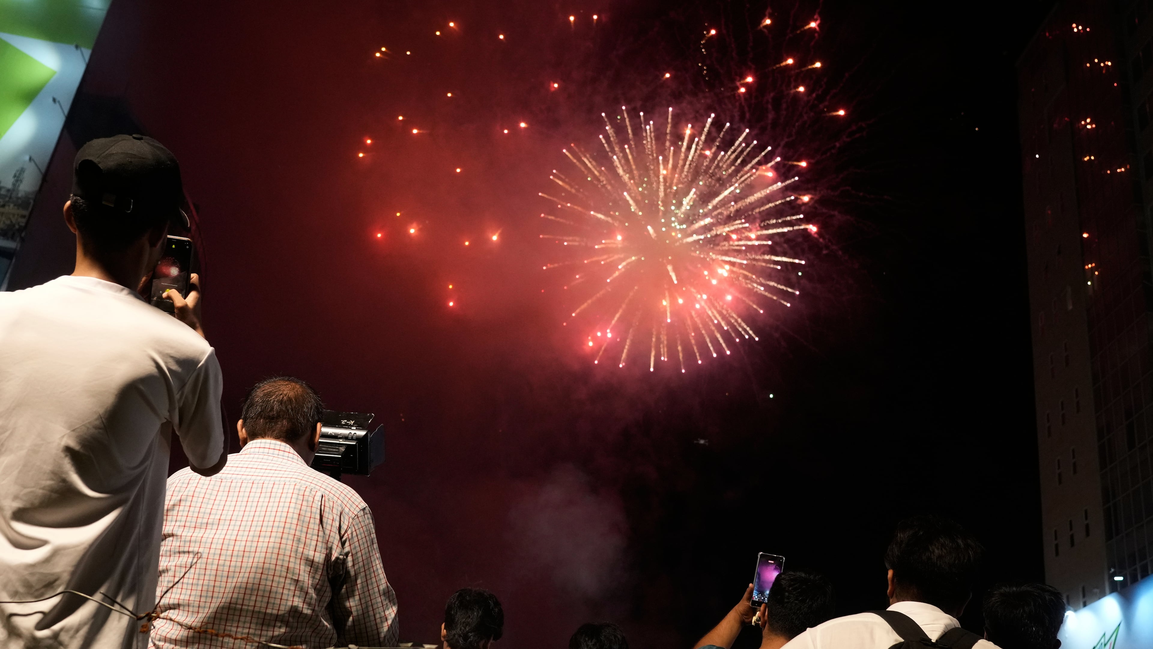 People watch fireworks in Lahore, Pakistan, Saturday, Aug. 8, 2026, during celebrations of the signing a trilateral defense agreement between Saudi Arabia, Pakistan and Turkey in Mecca. (AP Photo/K.M. Chaudary)