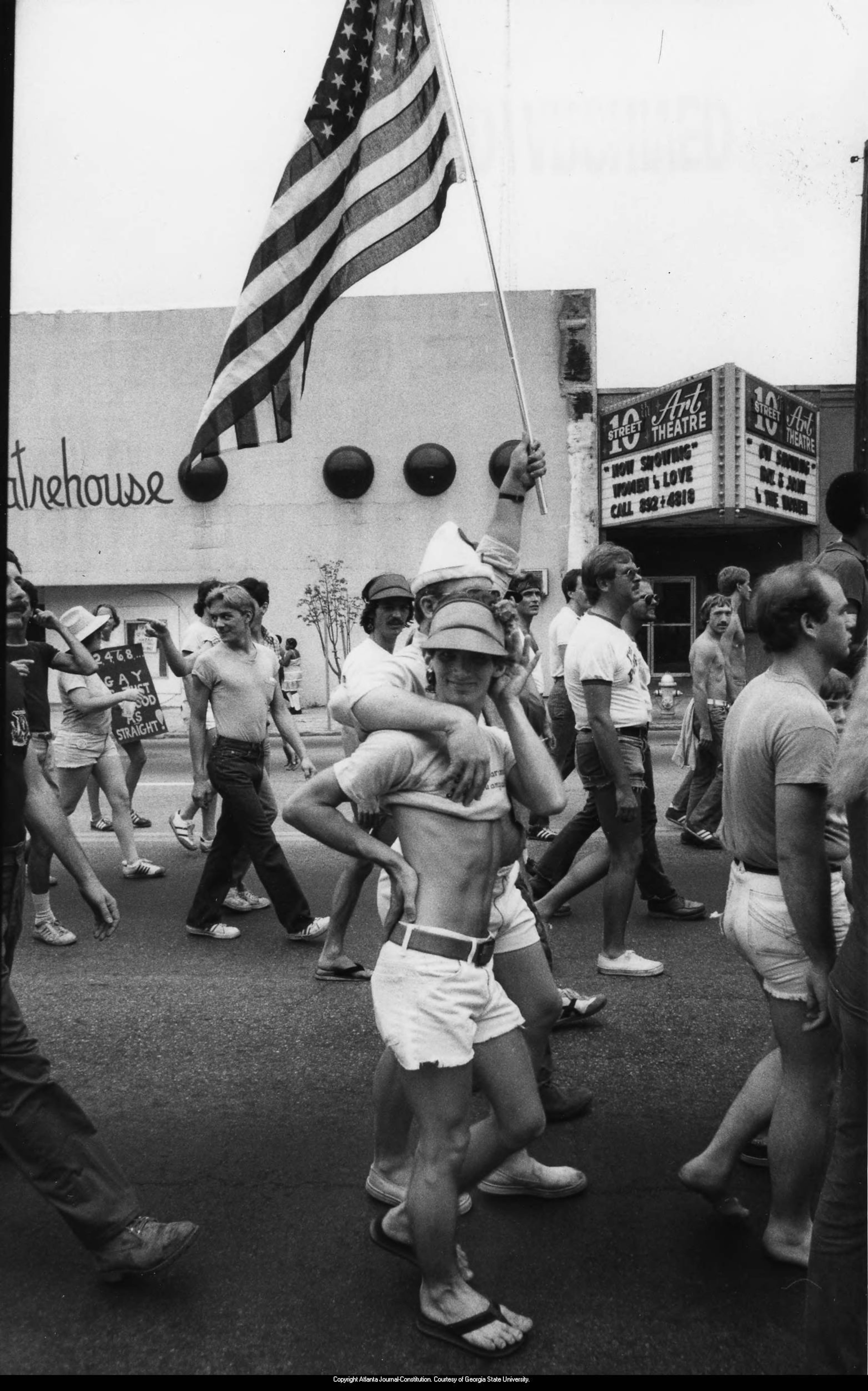 Marchers in a gay pride parade in front of the 10th Street Art Theatre, Atlanta, Georgia, June 26, 1979. PHOTO BY CALVUN CRUCE / AJC ARCHIVES