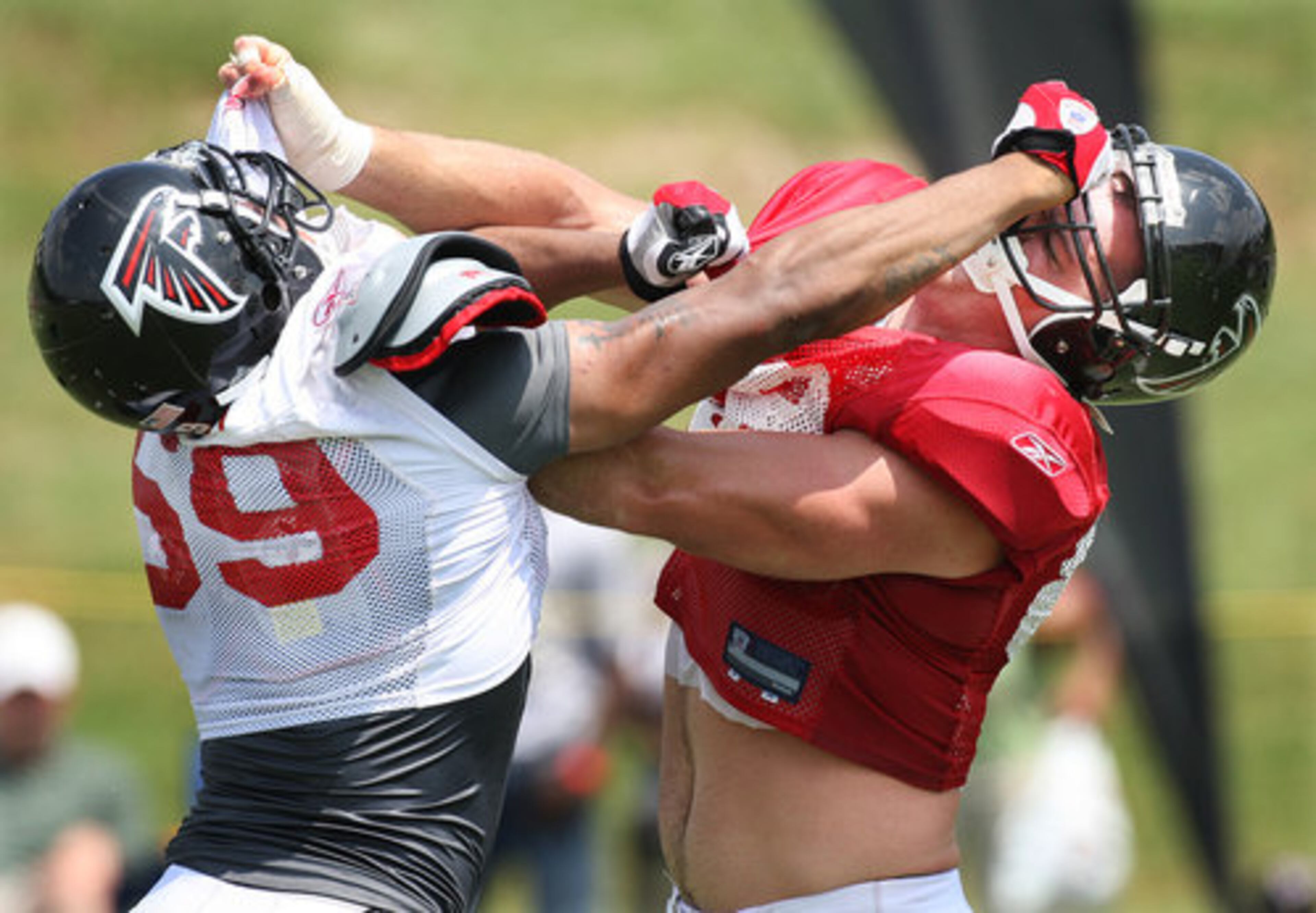 And at the Falcons training camp in Flowery Branch, linebacker Michael Boley (left) and tight end Keith Zinger bend each other backwards at the line of scrimmage during blocking drills on Wednesday.