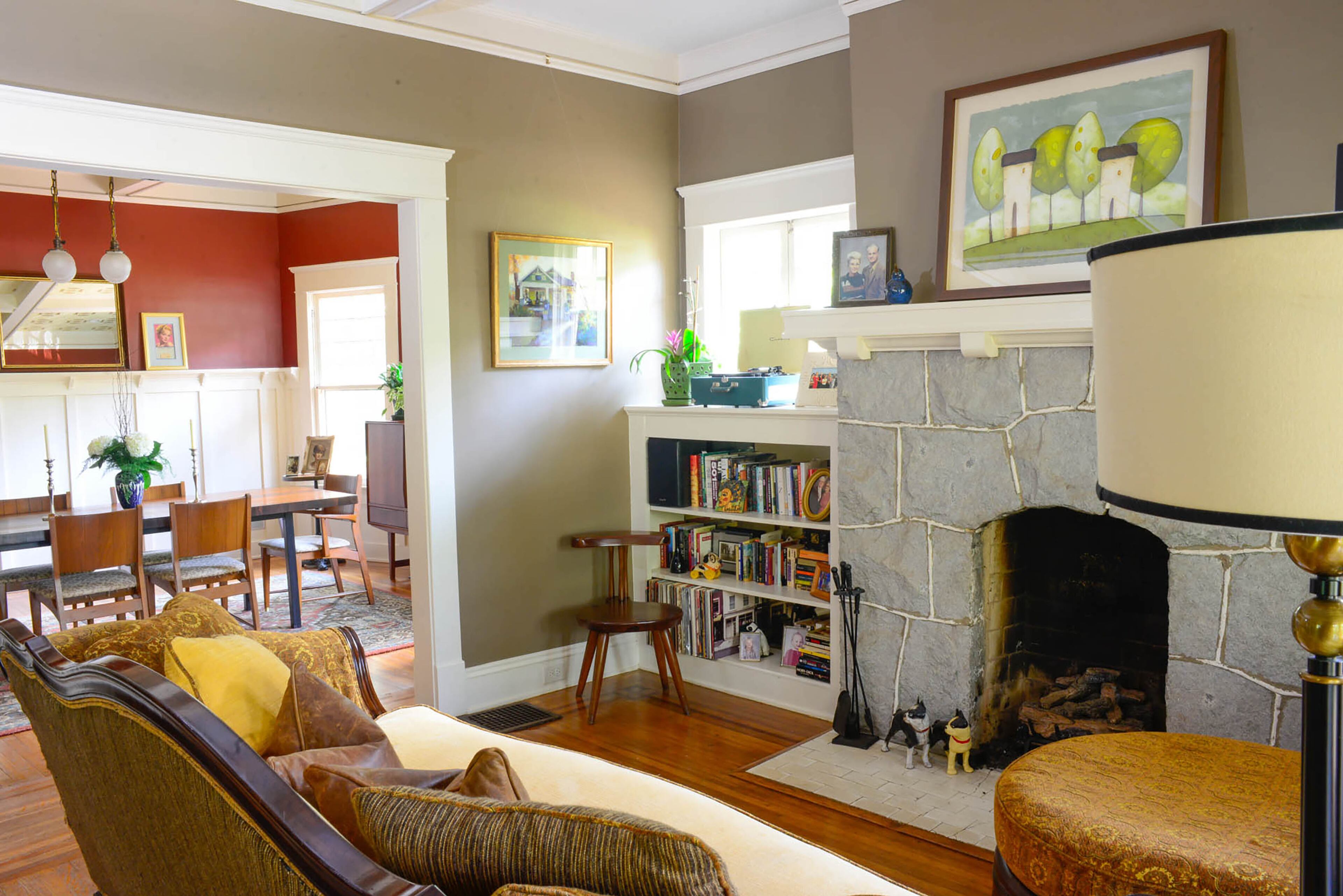 Grounds and Derrick's Craftsman-style home is on the Sept. 9-10 East Lake Tour of Homes. Coffered ceilings and granite fireplaces give the 102-year- old bungalow's living spaces a comfortable, collected feel. On the mantel, the couple
displays original artwork of trees and houses by Tracey Lewis, an Atlanta artist.
