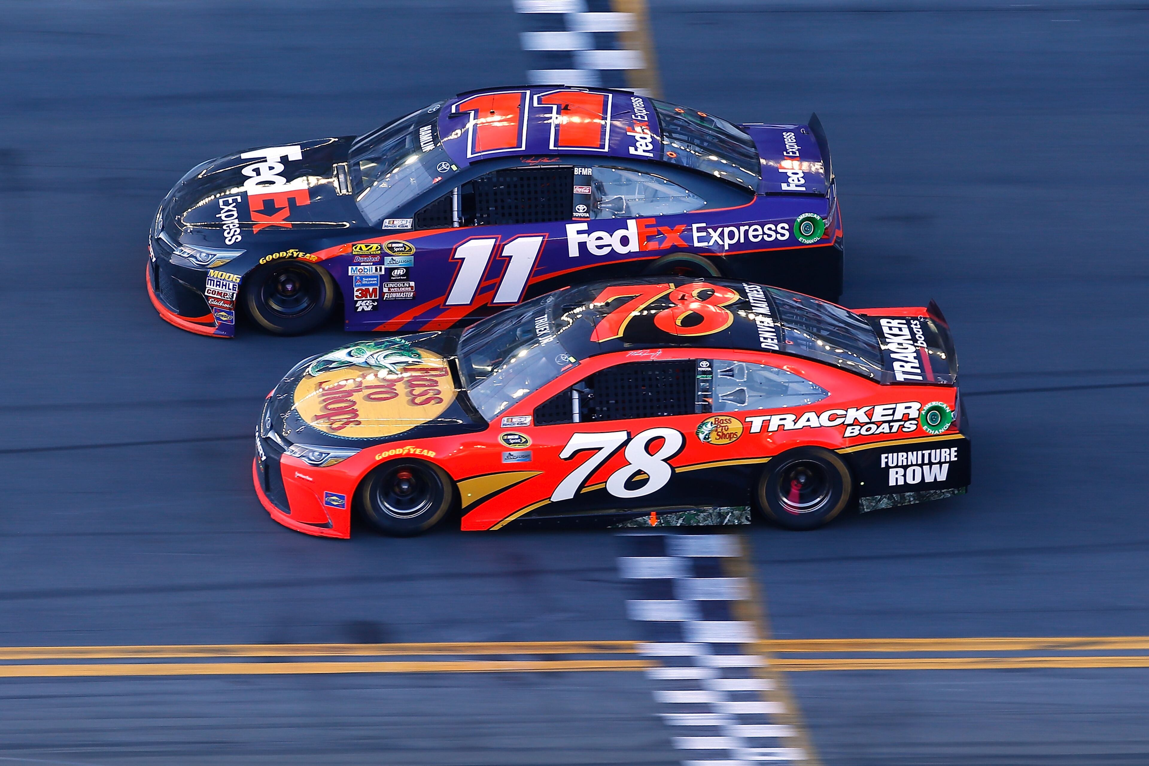 Denny Hamlin, driver of the #11 FedEx Express Toyota, takes the checkered flag ahead of Martin Truex Jr., driver of the #78 Bass Pro Shops/Tracker Boats Toyota, to win the NASCAR Sprint Cup Series DAYTONA 500 at Daytona International Speedway on February 21, 2016 in Daytona Beach, Florida. (Photo by Jonathan Ferrey/Getty Images)